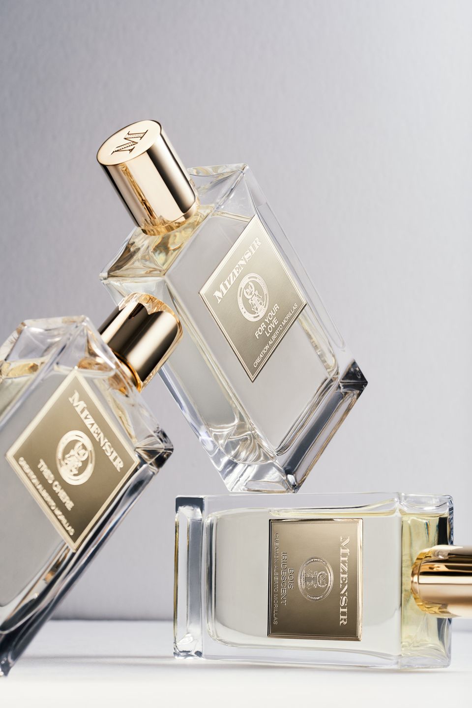 Close-up of Mizensir fragrance bottles, showcasing their refined design and luxurious metal labels