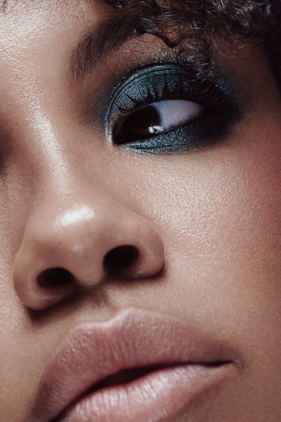  Extreme close-up of Muriel’s eye, emphasizing the shimmer and detail of the teal eyeshadow.