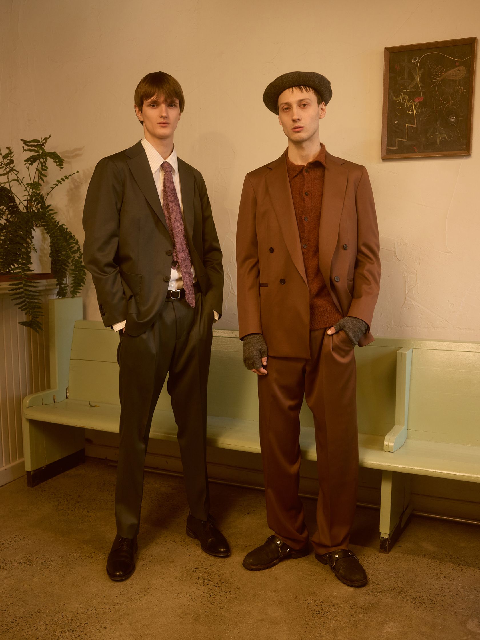 two men in suits standing next to each other