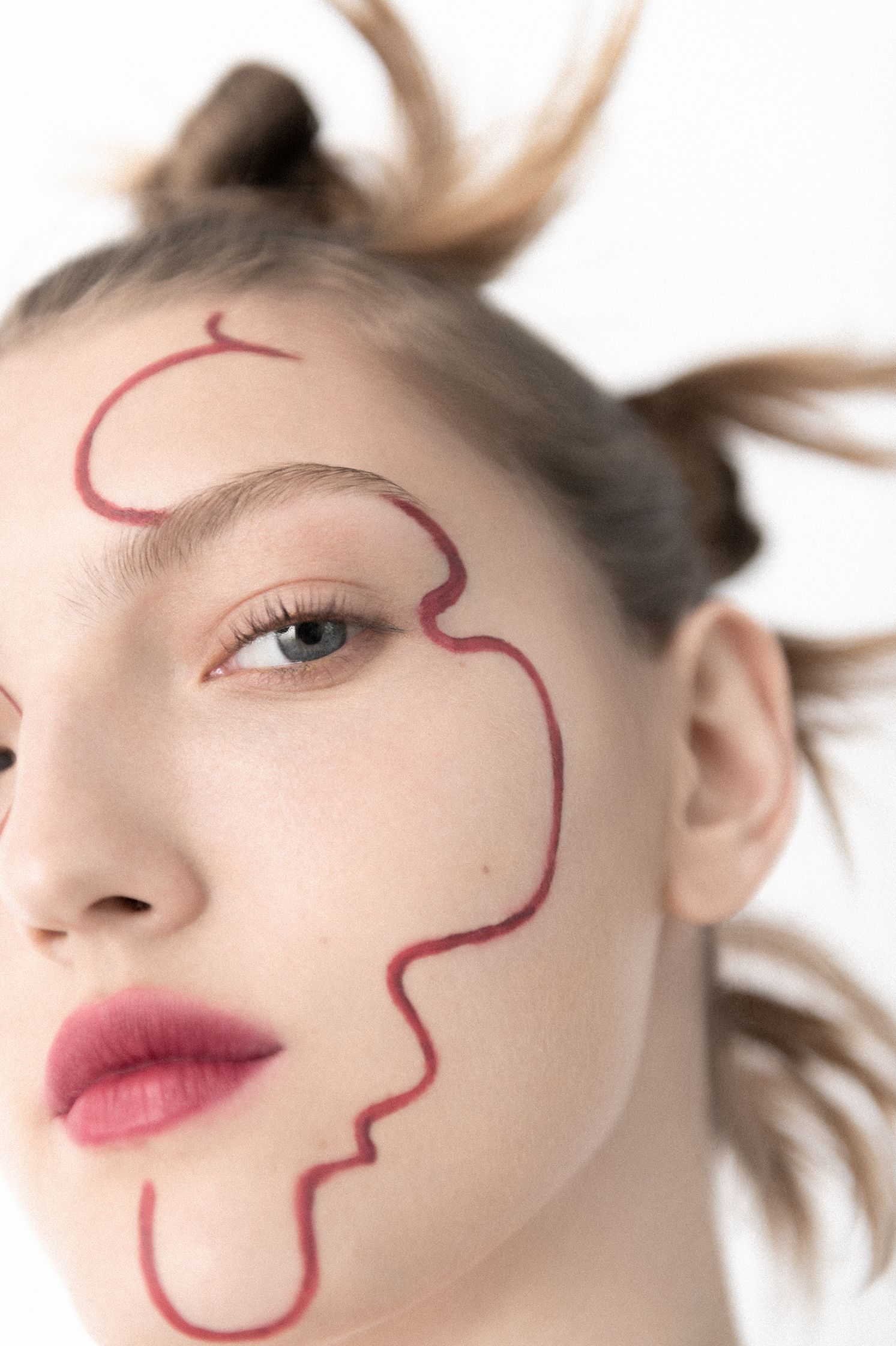 a woman with red makeup on her face