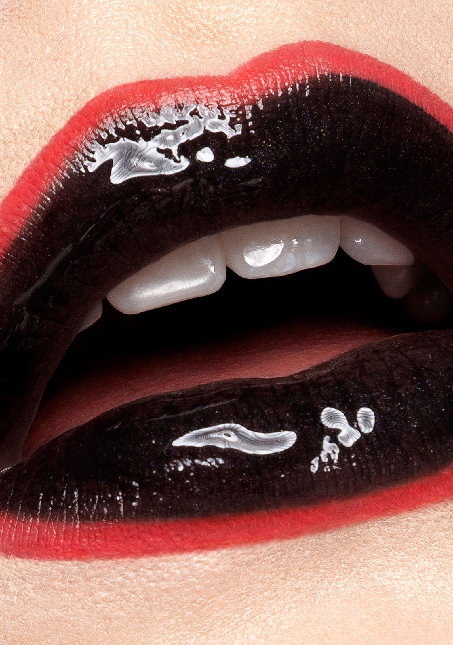 a close up of a woman's lips with black and red lipstick beauty post production