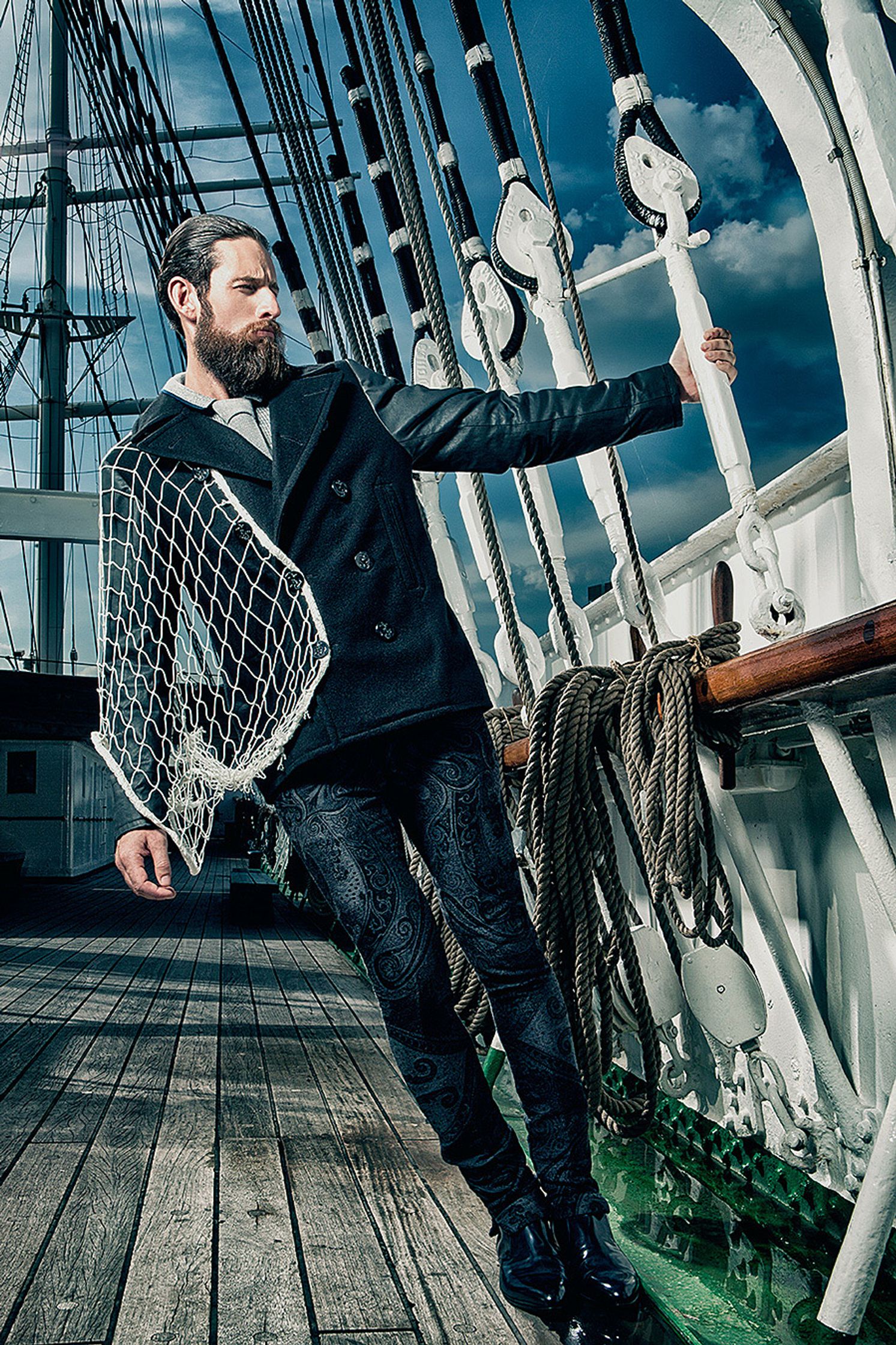 a bearded man standing on the deck of a ship Creative Retouching Hamburg