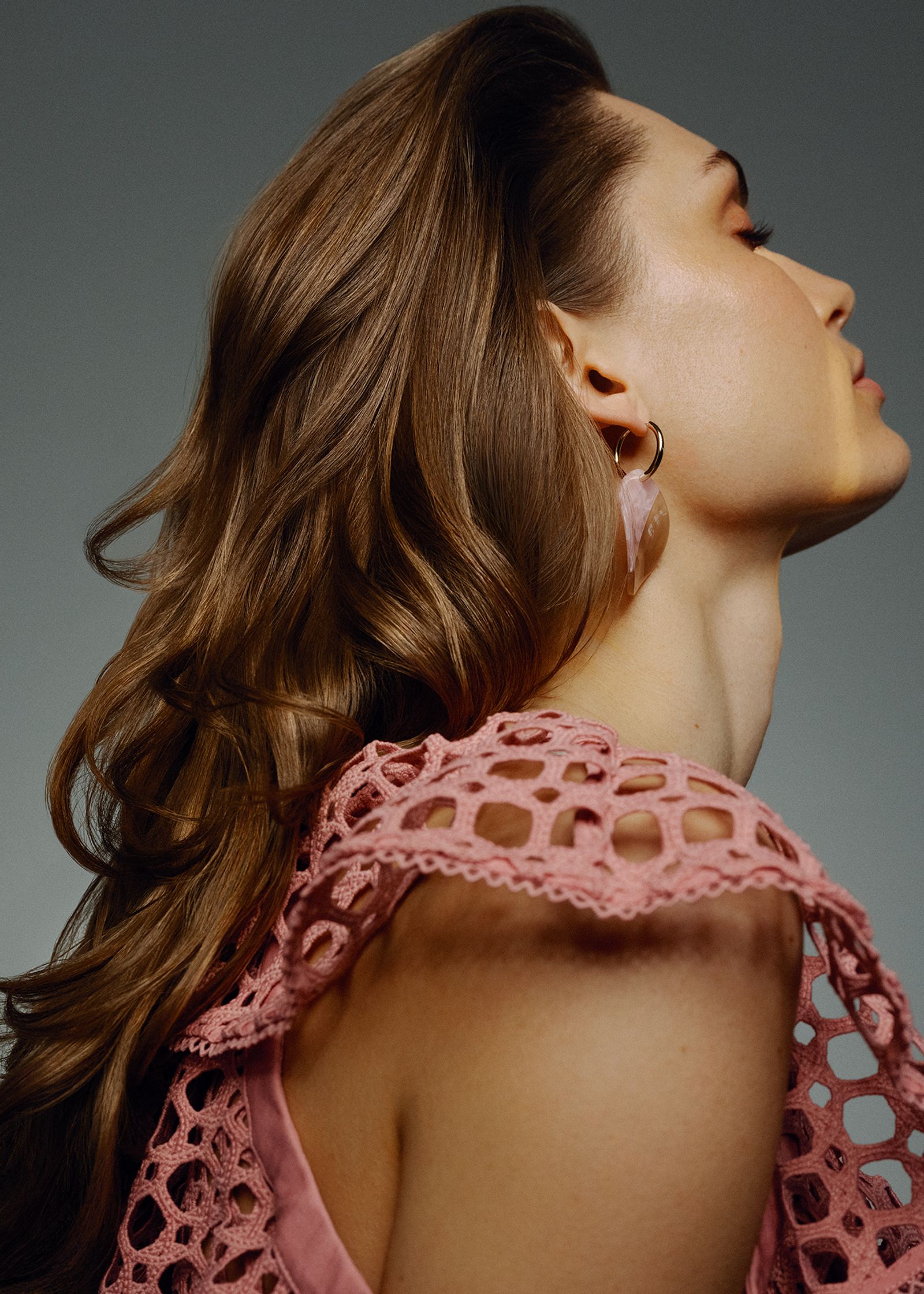 a woman with long hair in a pink dress