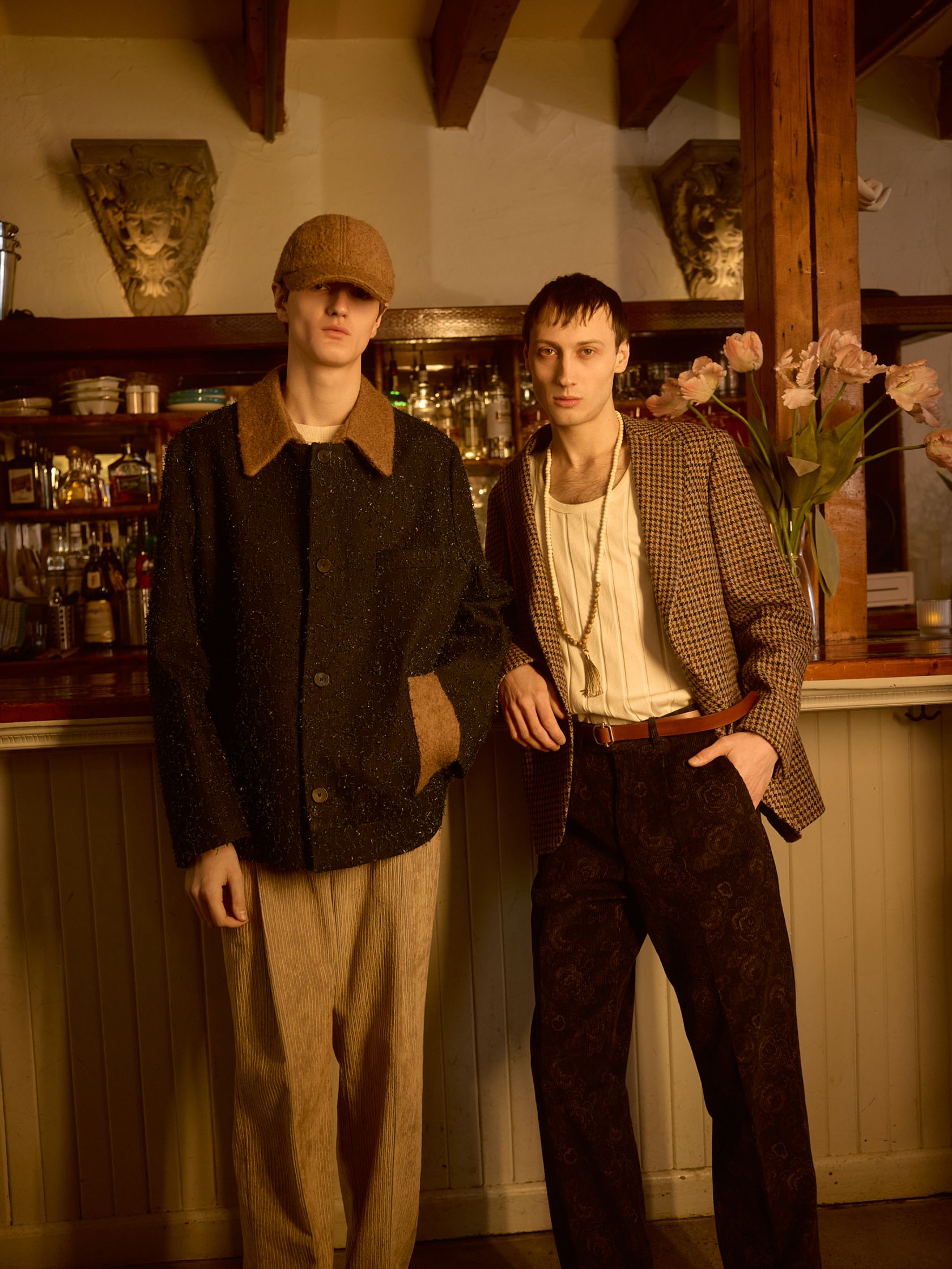 two men standing in front of a bar