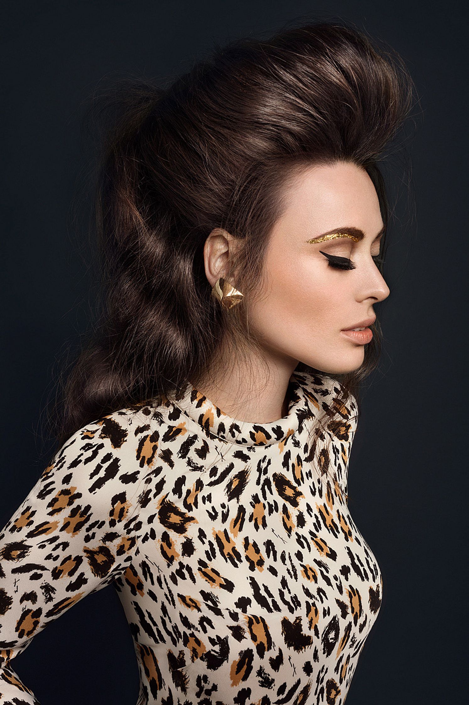 a beautiful coletta tornier in a leopard print top posing on a black background hair and beauty hamburg