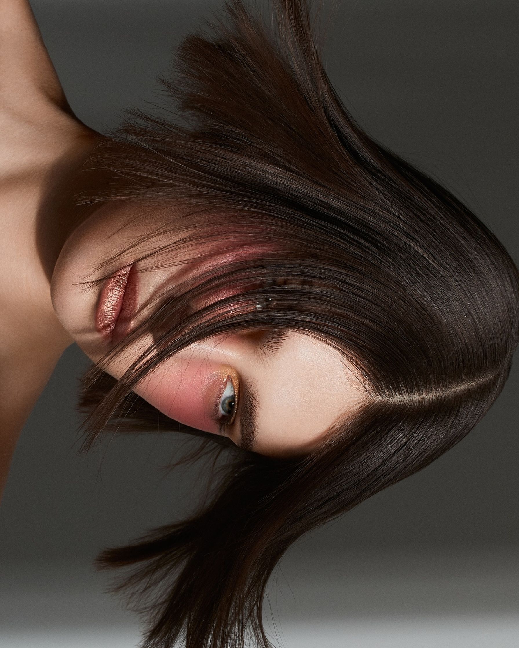 a young woman with long brown hair is posing for a photo