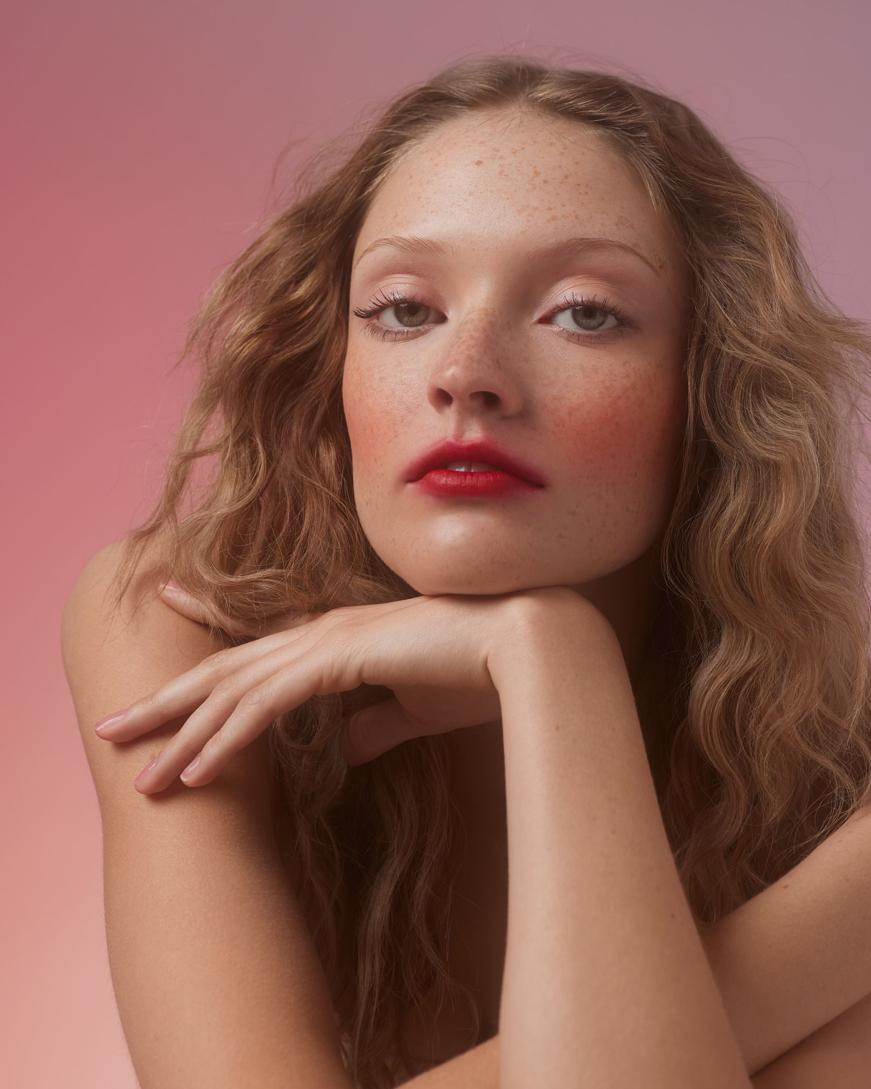 a woman with freckles posing for a photo