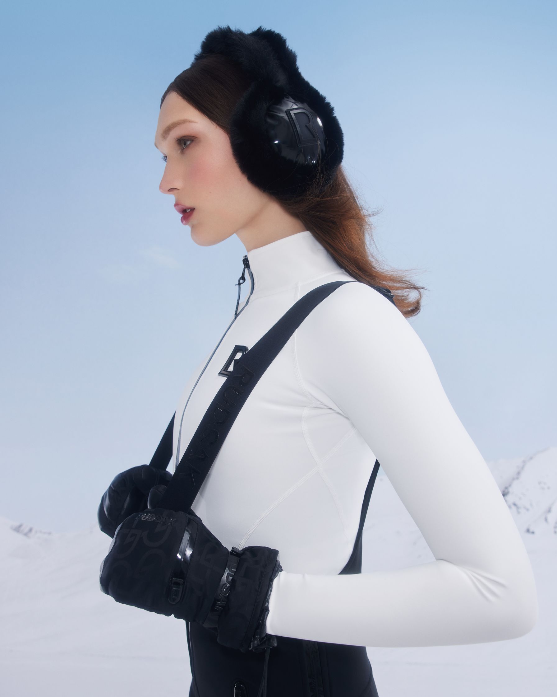 a woman wearing ski gear and ear muffs