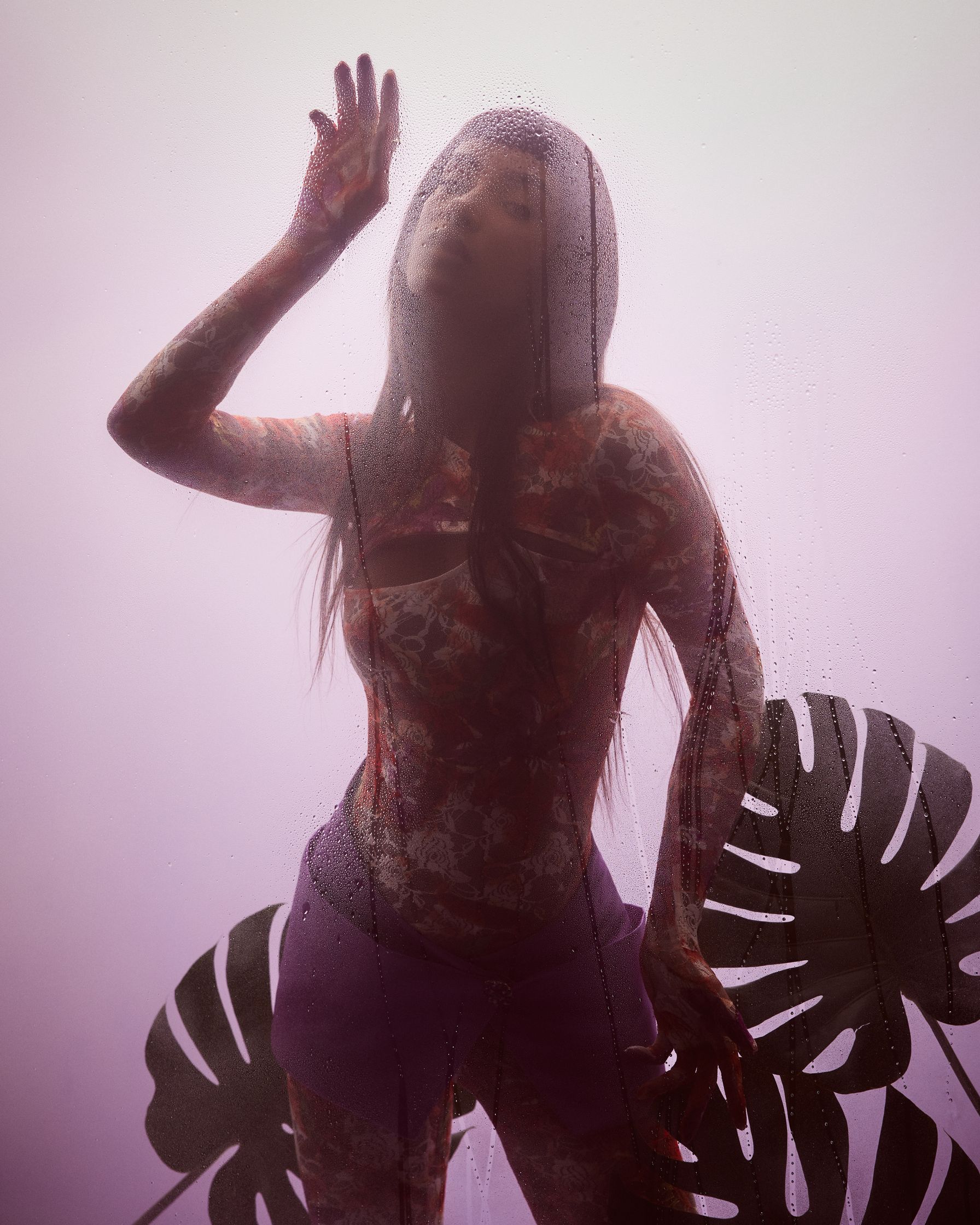 a woman is standing in front of a purple wall