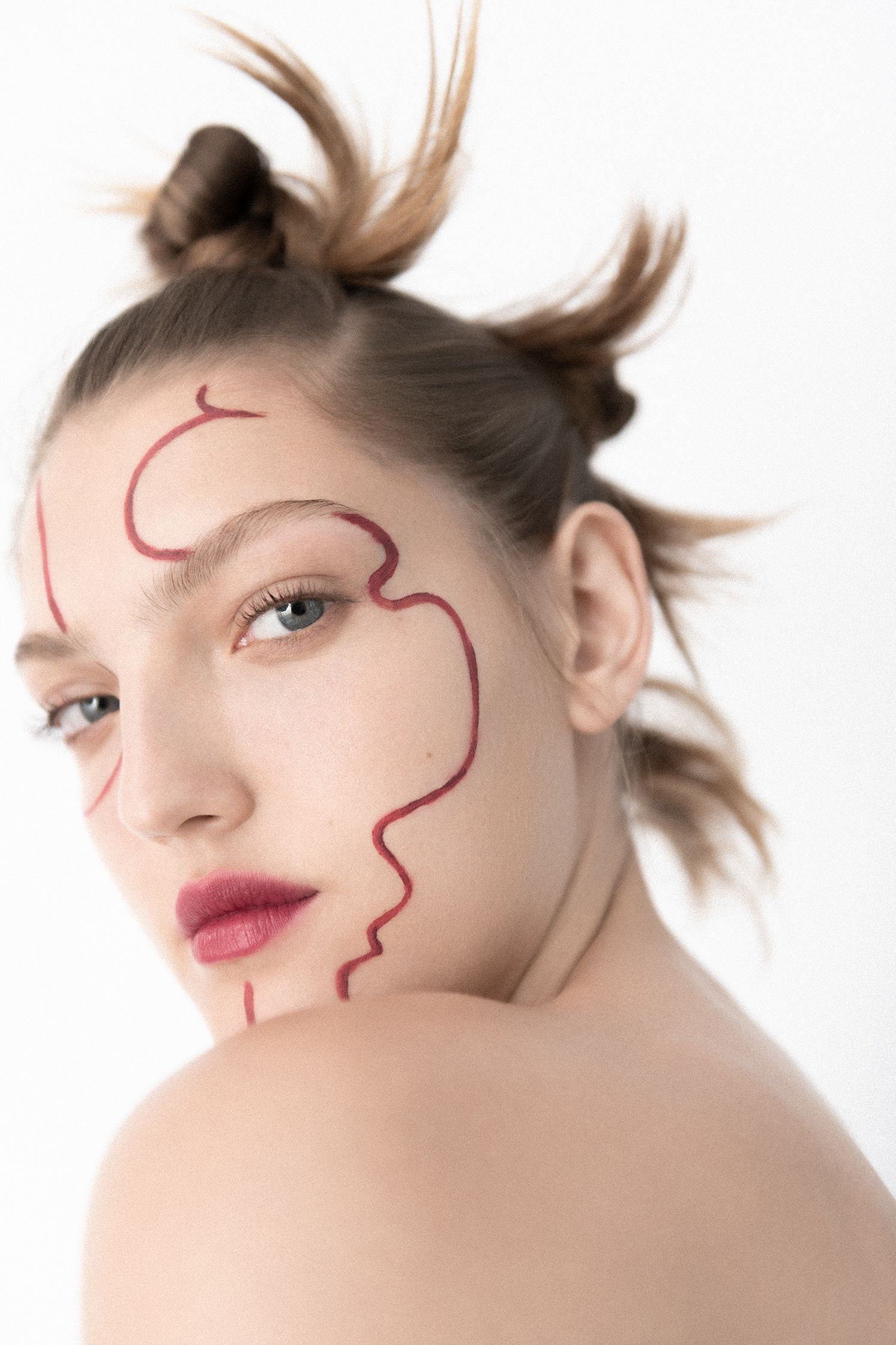 a woman with red makeup on her face