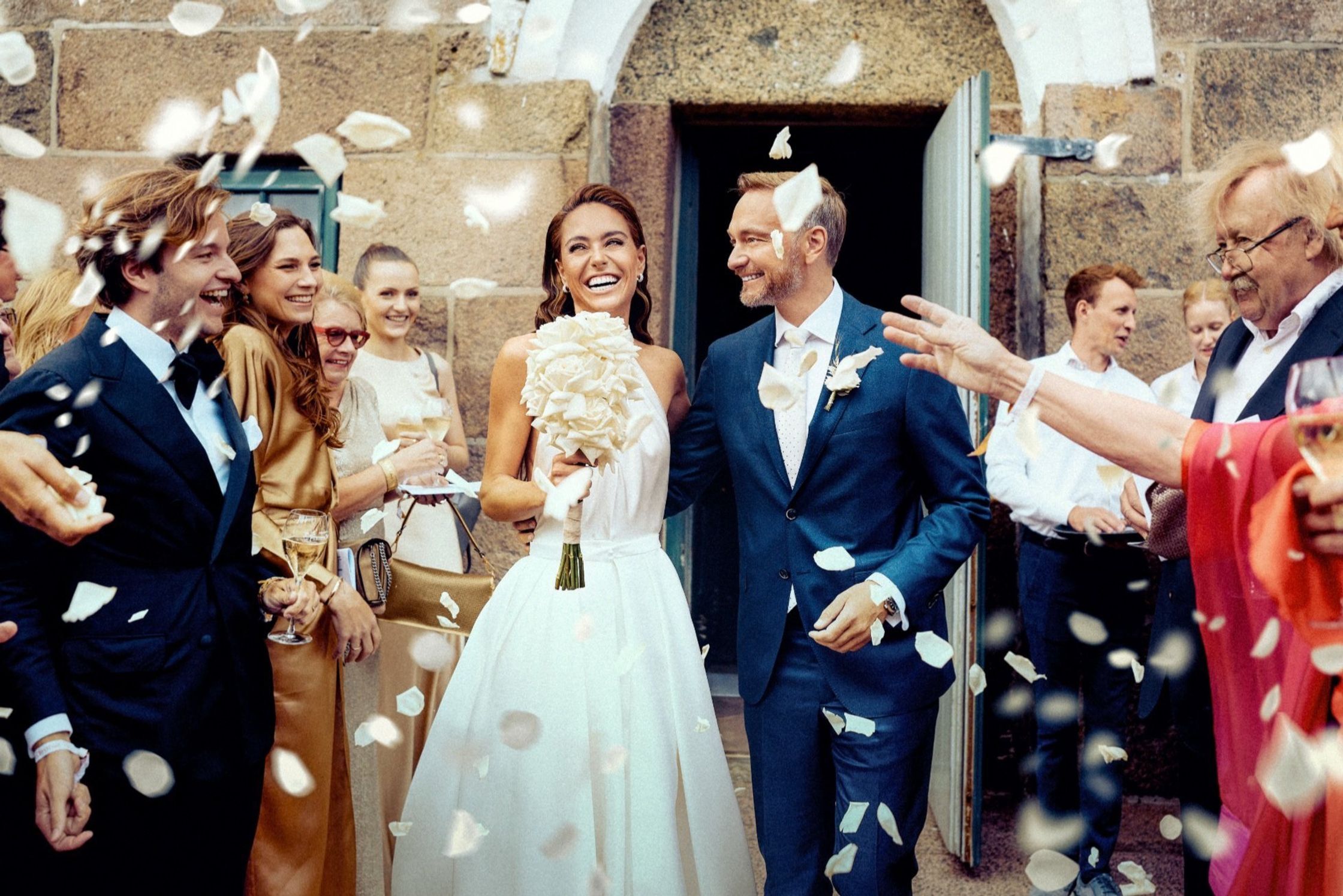 a bride and groom with confetti thrown at them