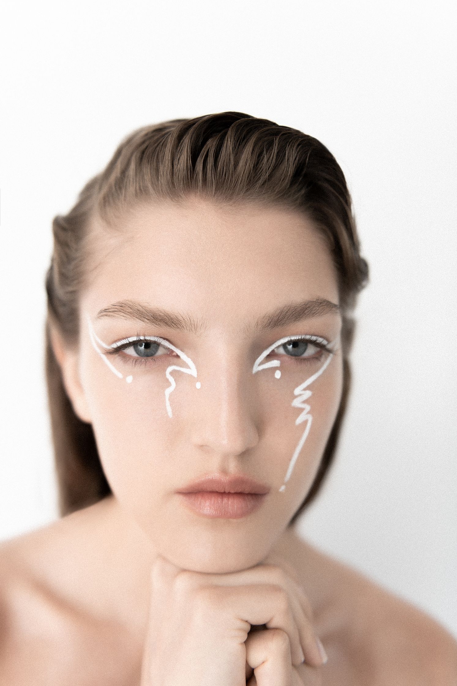 a woman with white makeup on her face