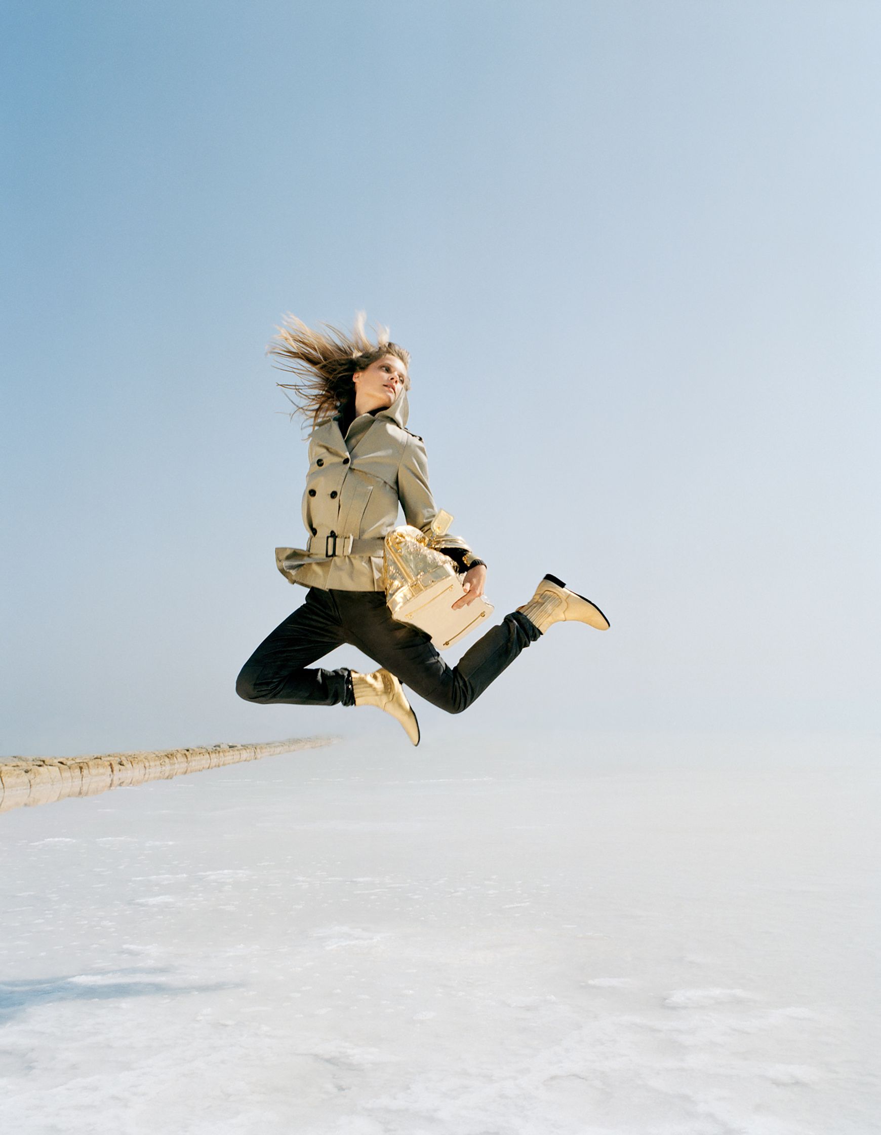 a woman jumping in the air over a frozen lake editorial retouching hamburg