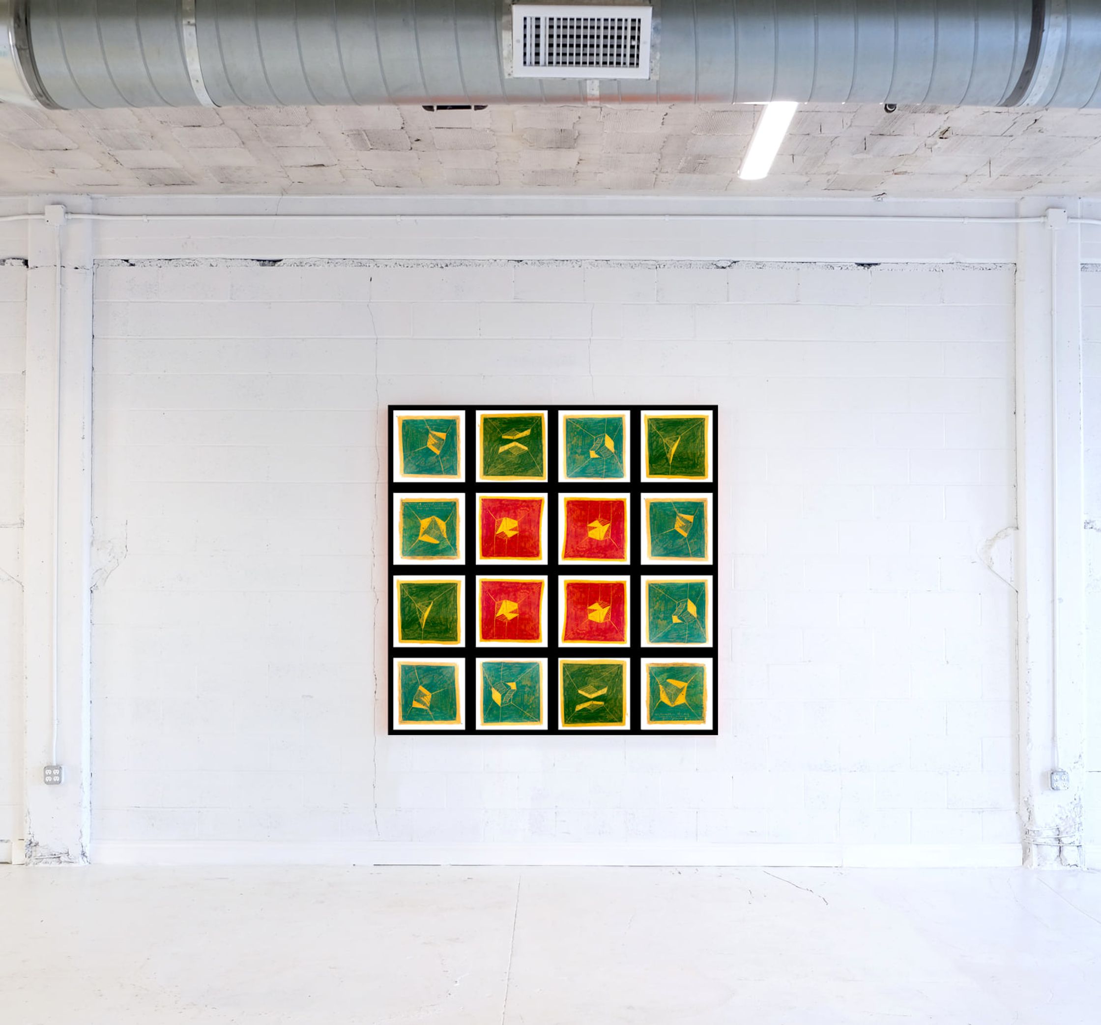 a red, green, and yellow painting on a white wall