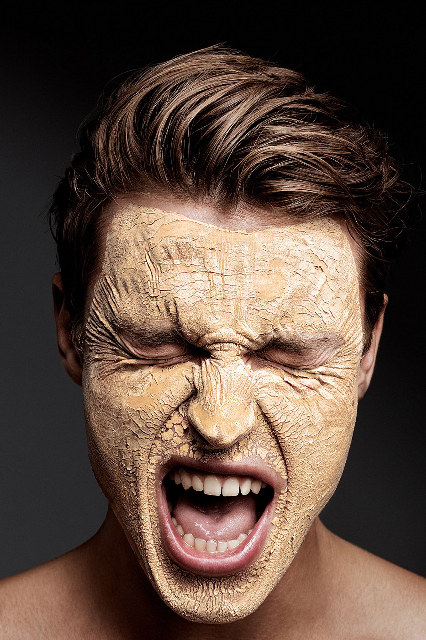 a man with a mud mask on his face men cosmetic post production hamburg