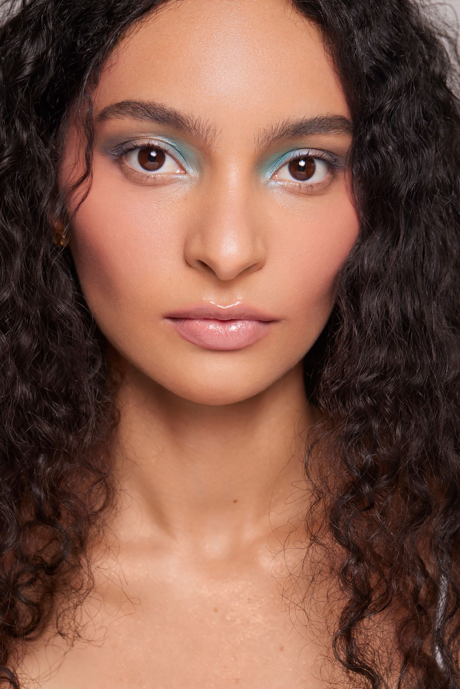 a woman with curly hair posing for a photo