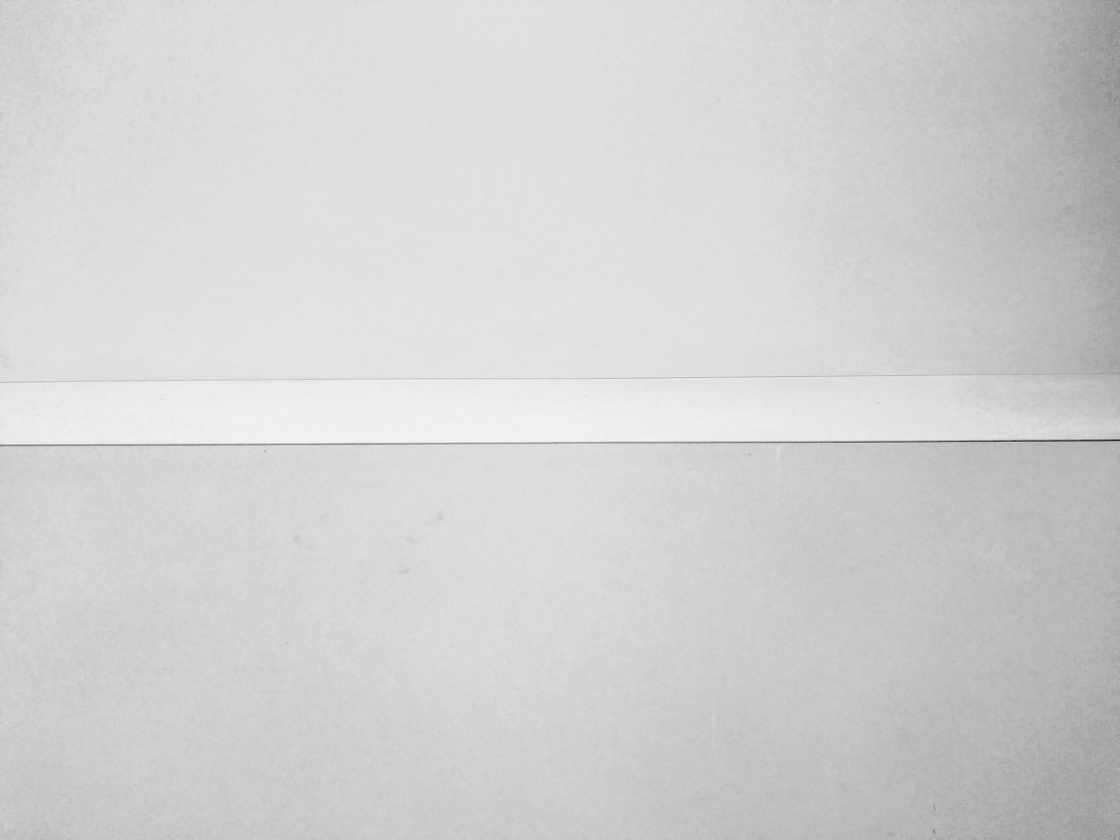 a white shelf on a white wall