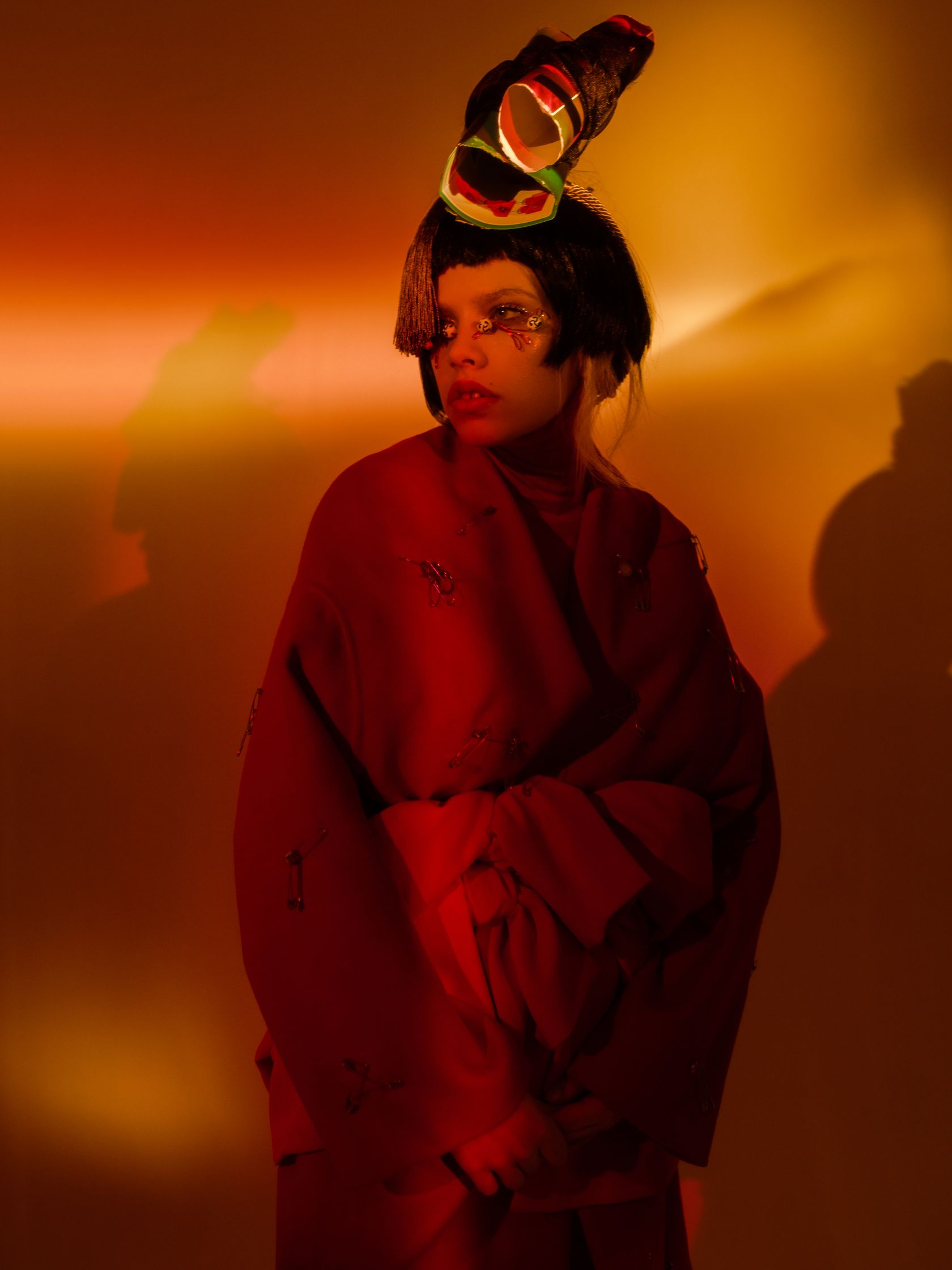 a woman wearing a red kimono and hat