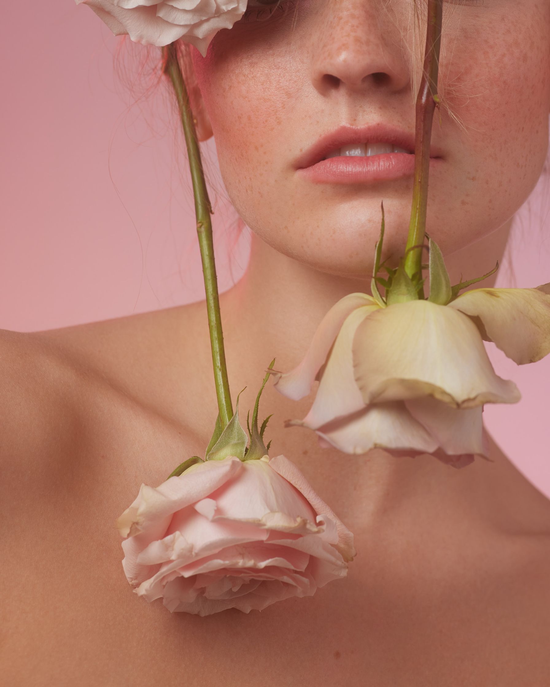 a woman with pink hair and flowers on her head