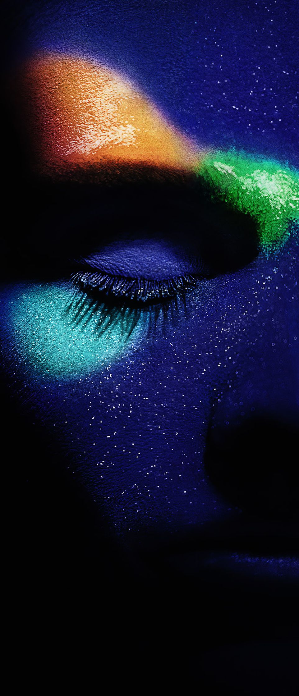 a woman's face with colorful paint on it post production