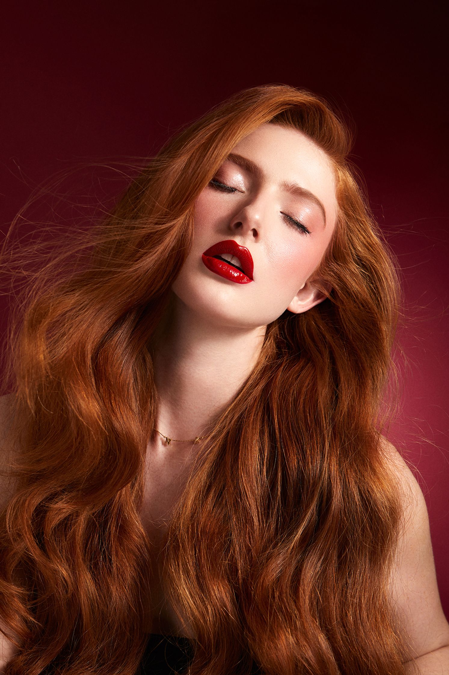 a beautiful woman with long red hair and red lipstick