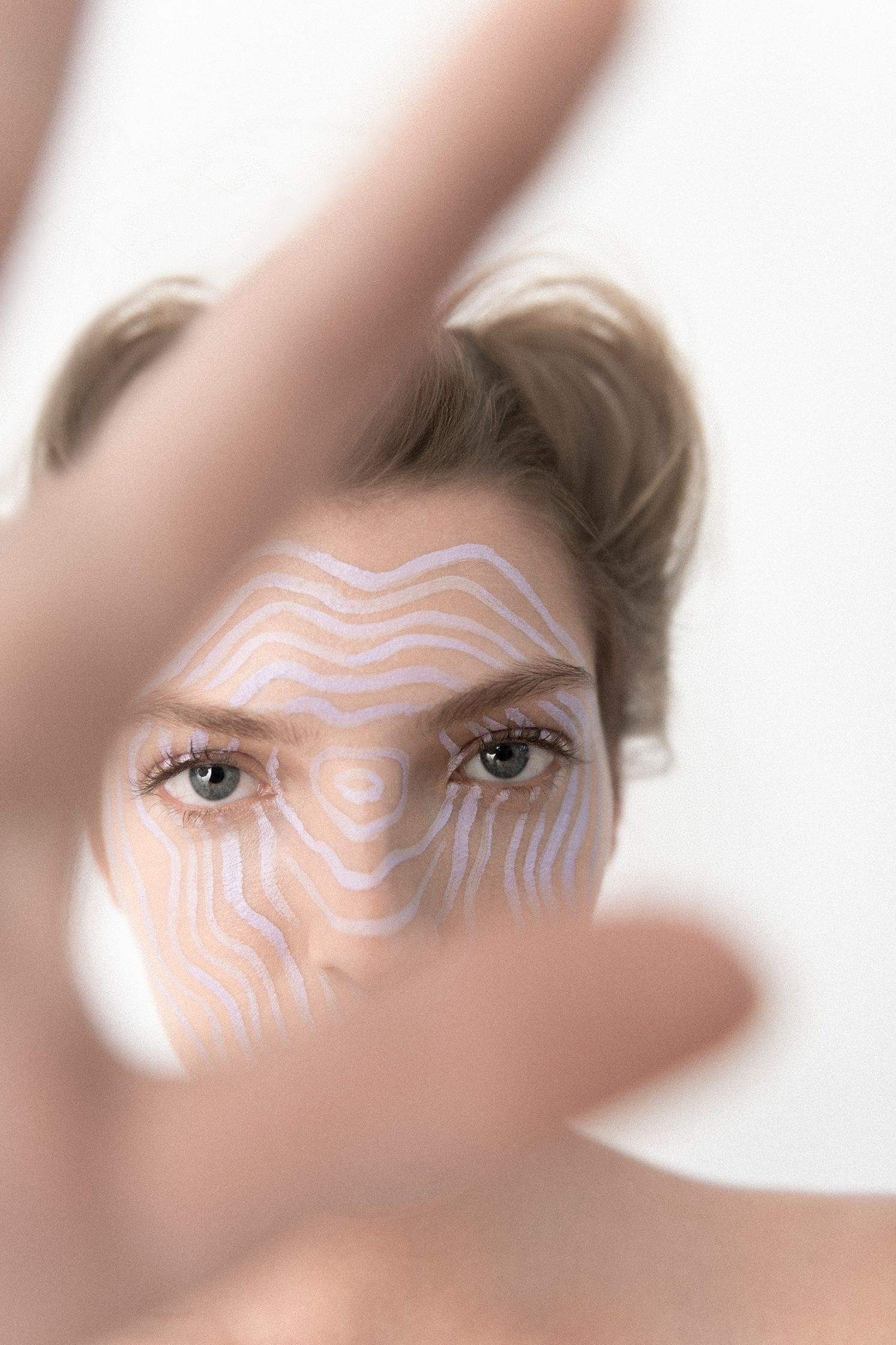 a woman's face is painted with a pattern