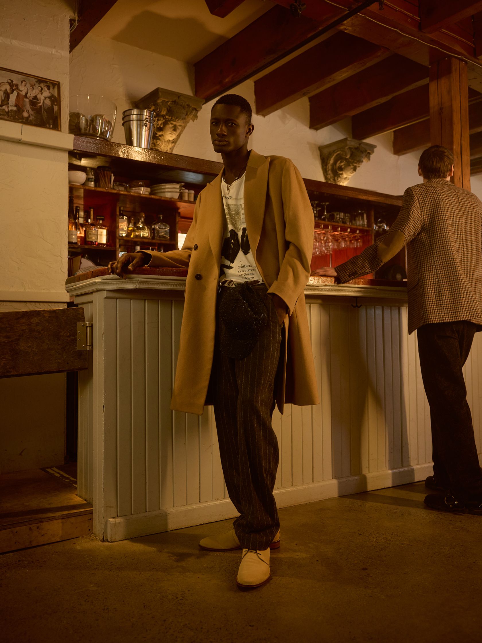 a man standing in front of a bar