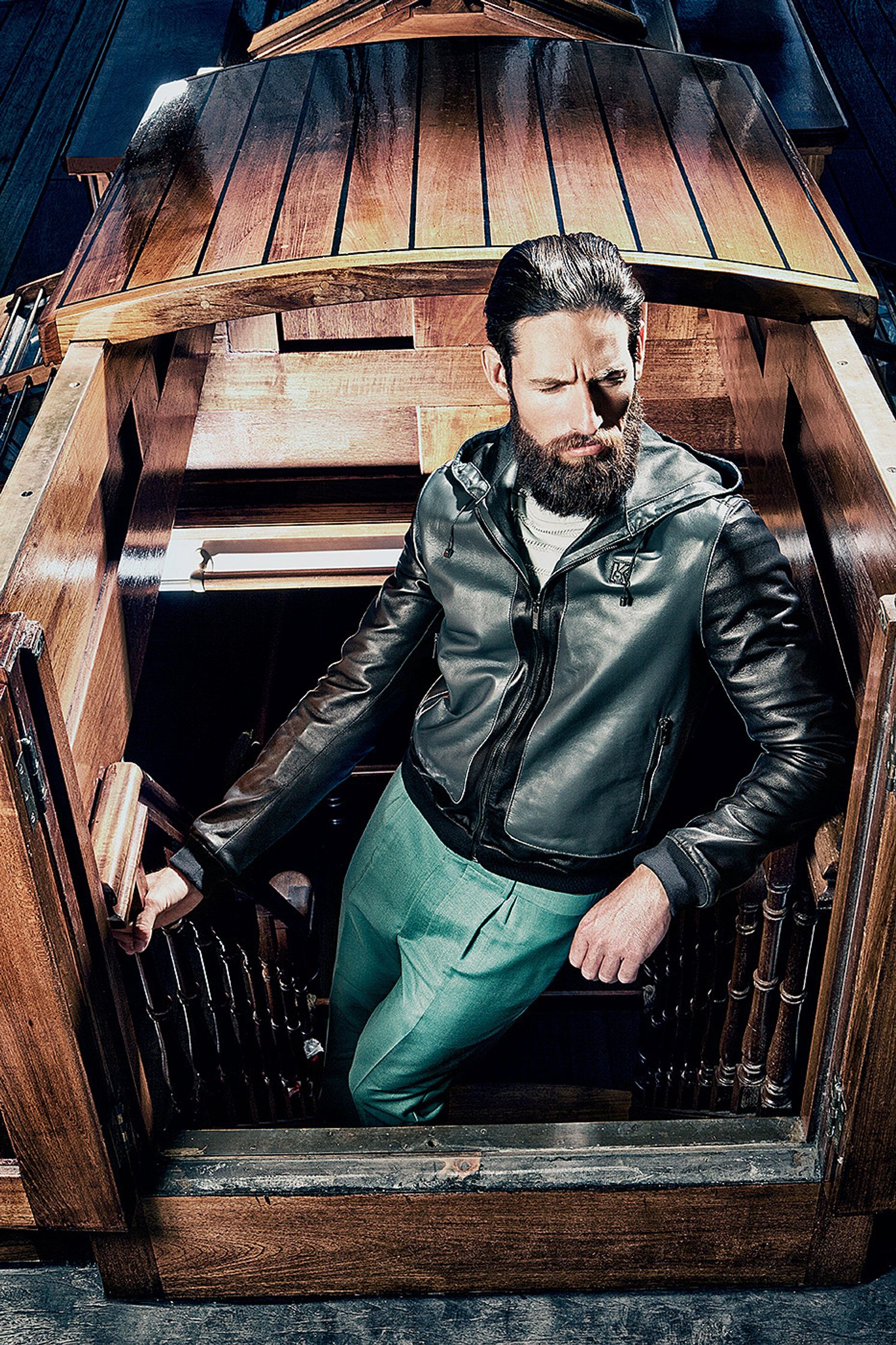 a man with a beard standing in a wooden boat Creative Retouching Hamburg