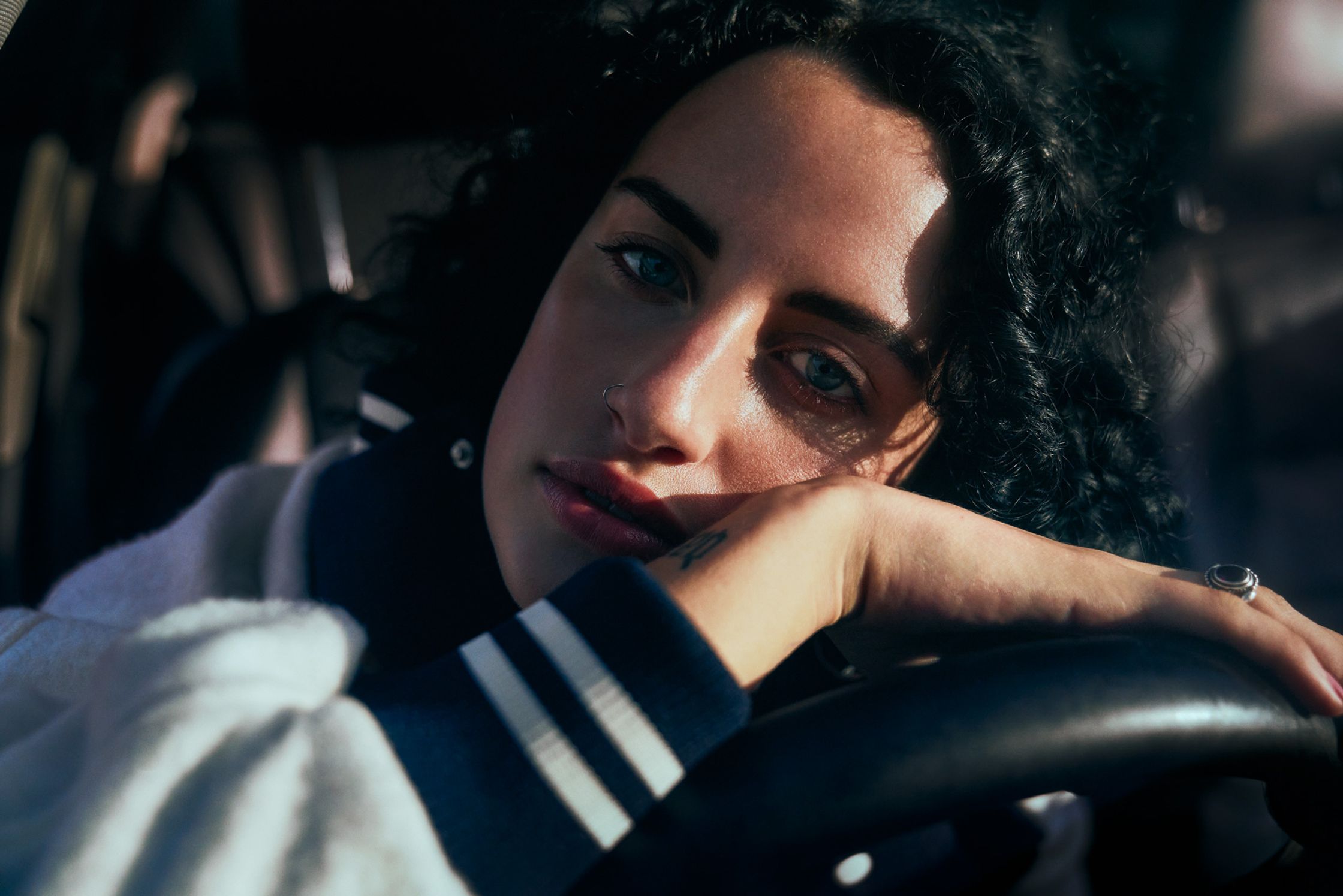 a woman sitting in the driver's seat of a car