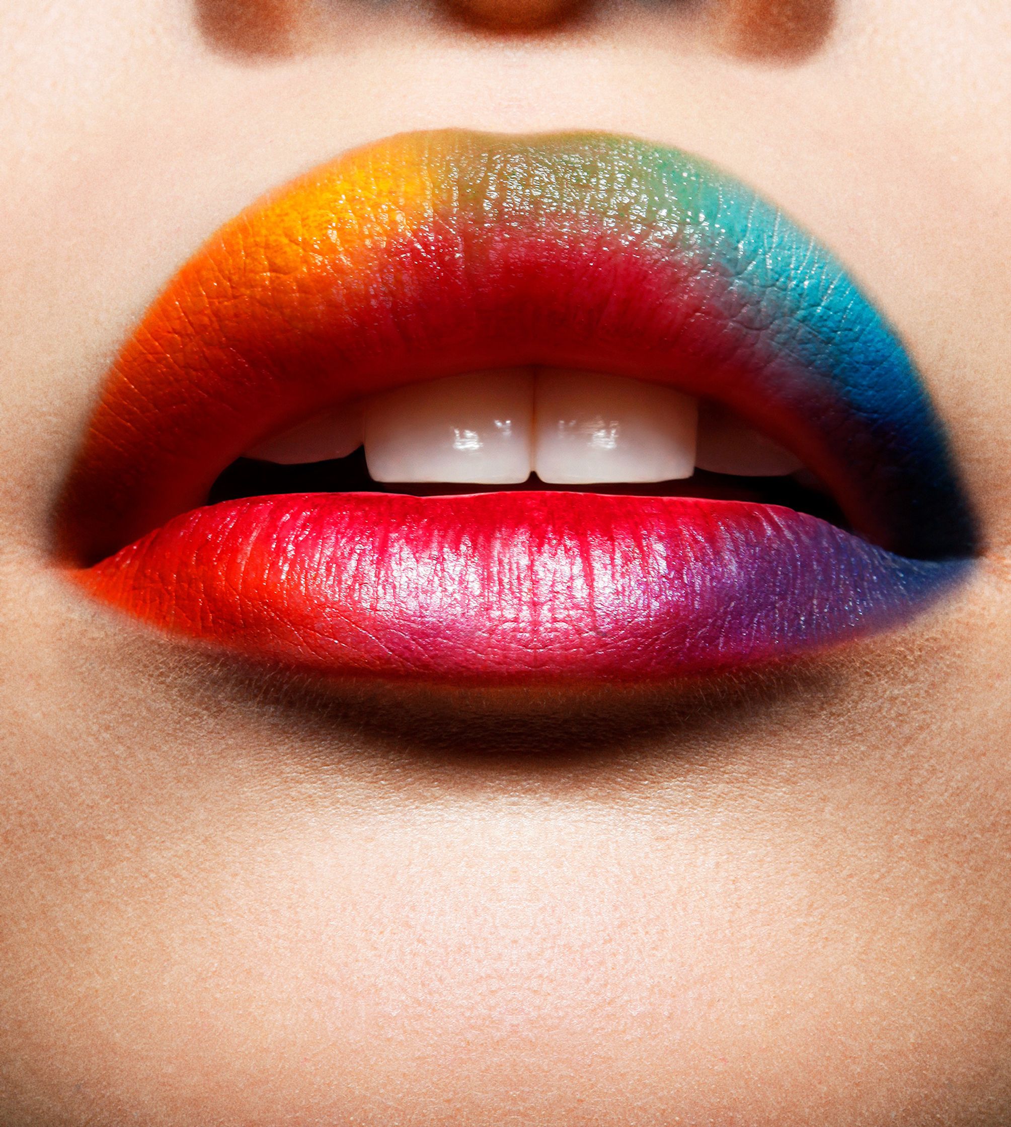 a close up of a woman's lips with colorful paint glamour retouch