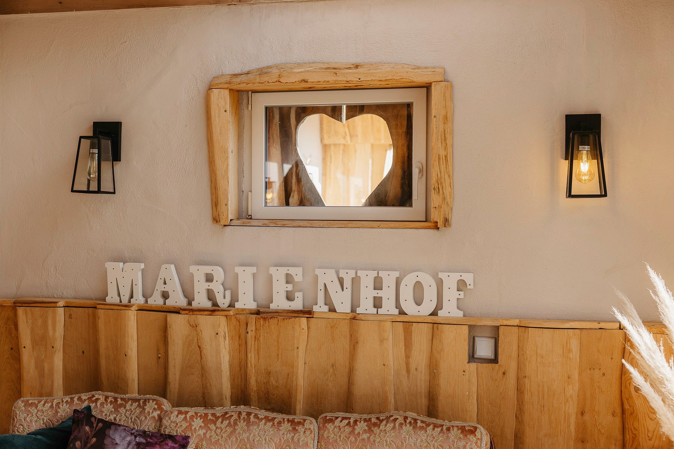 Ein Zimmer mit einer Couch und einem Schild mit der Aufschrift „Marienhof“.