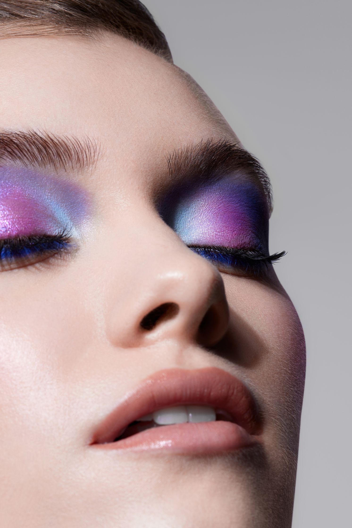 a woman with purple and blue eye makeup