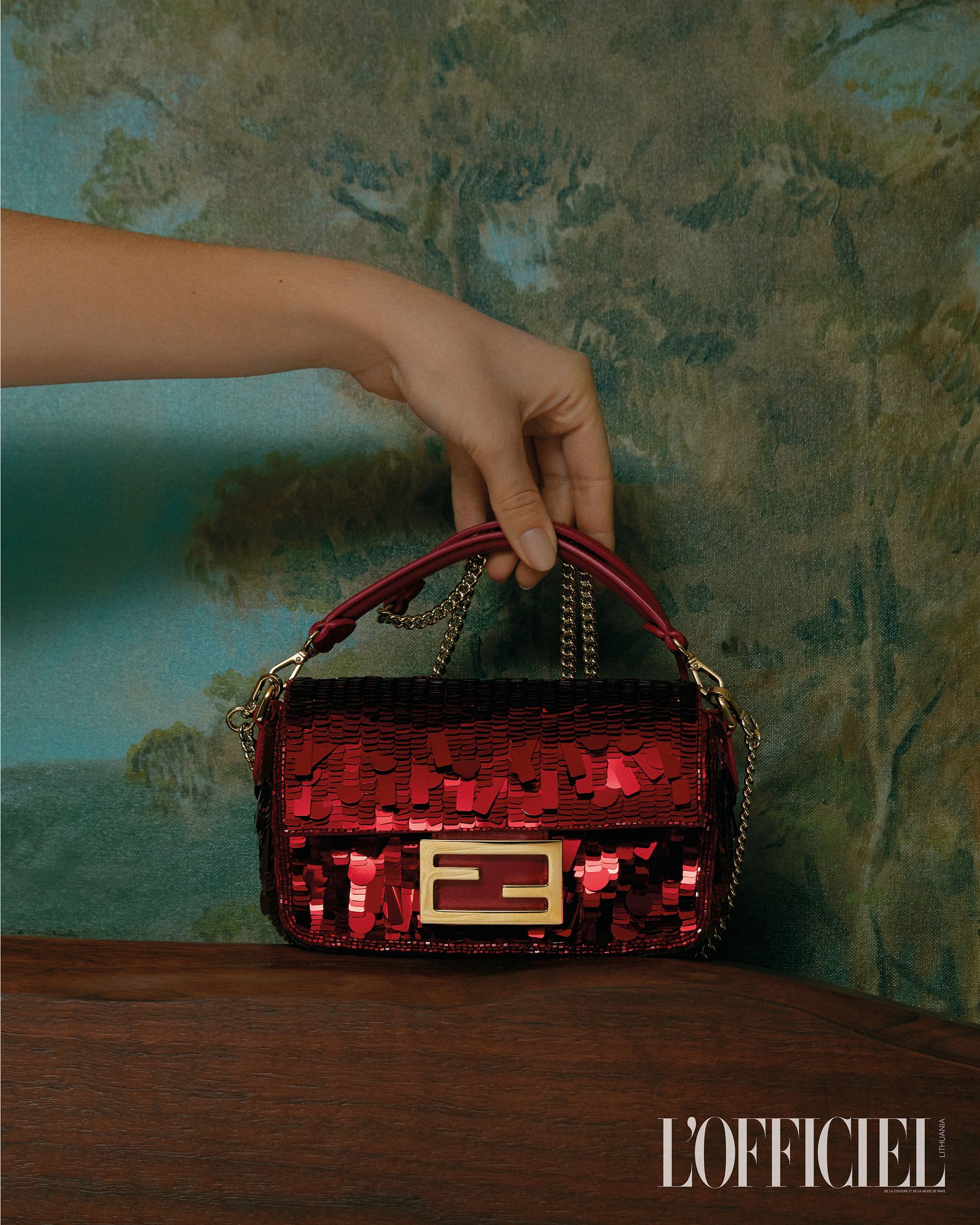 a woman is holding a red sequin bag