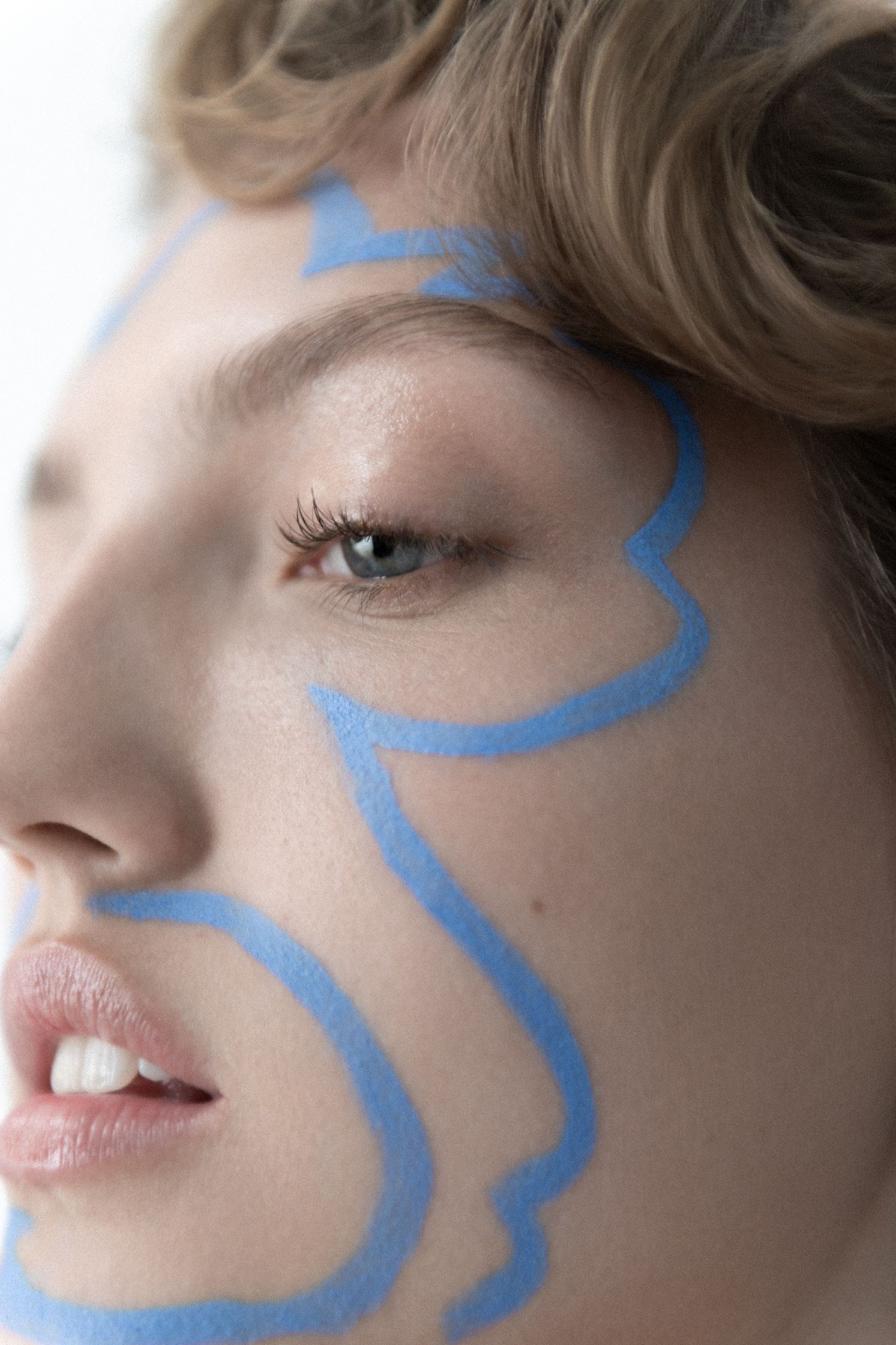 a woman with blue paint on her face