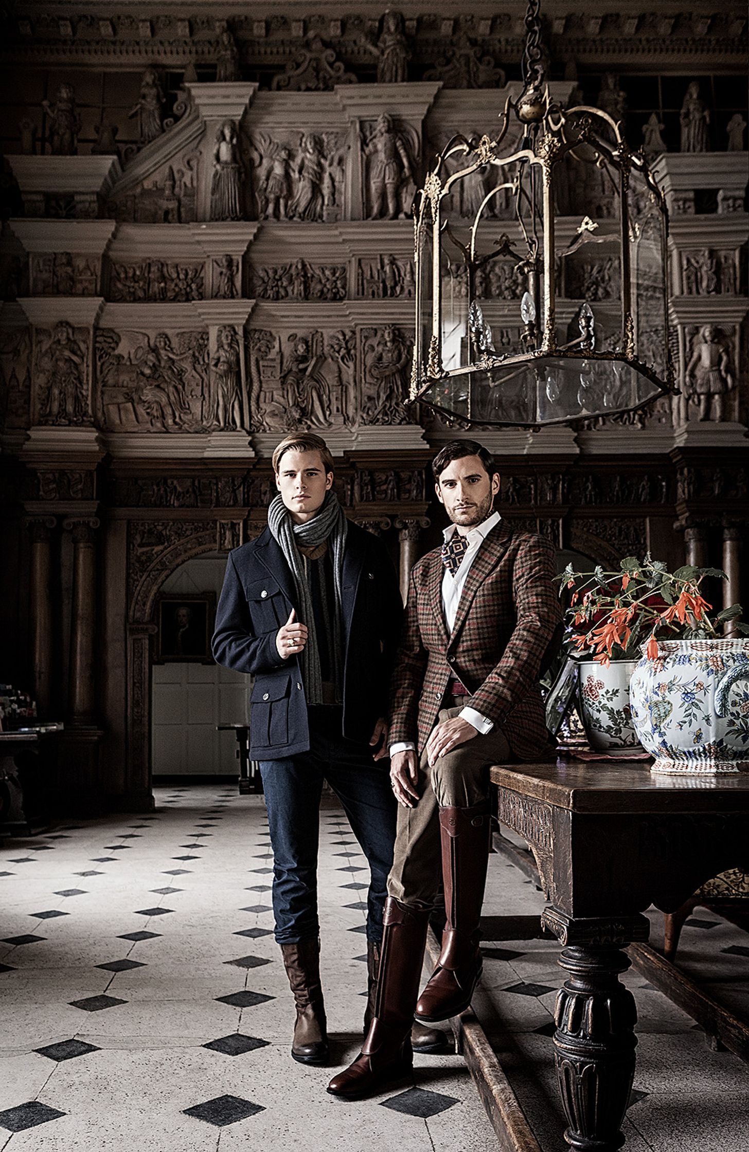 two men posing for a picture in an ornate room creative post production