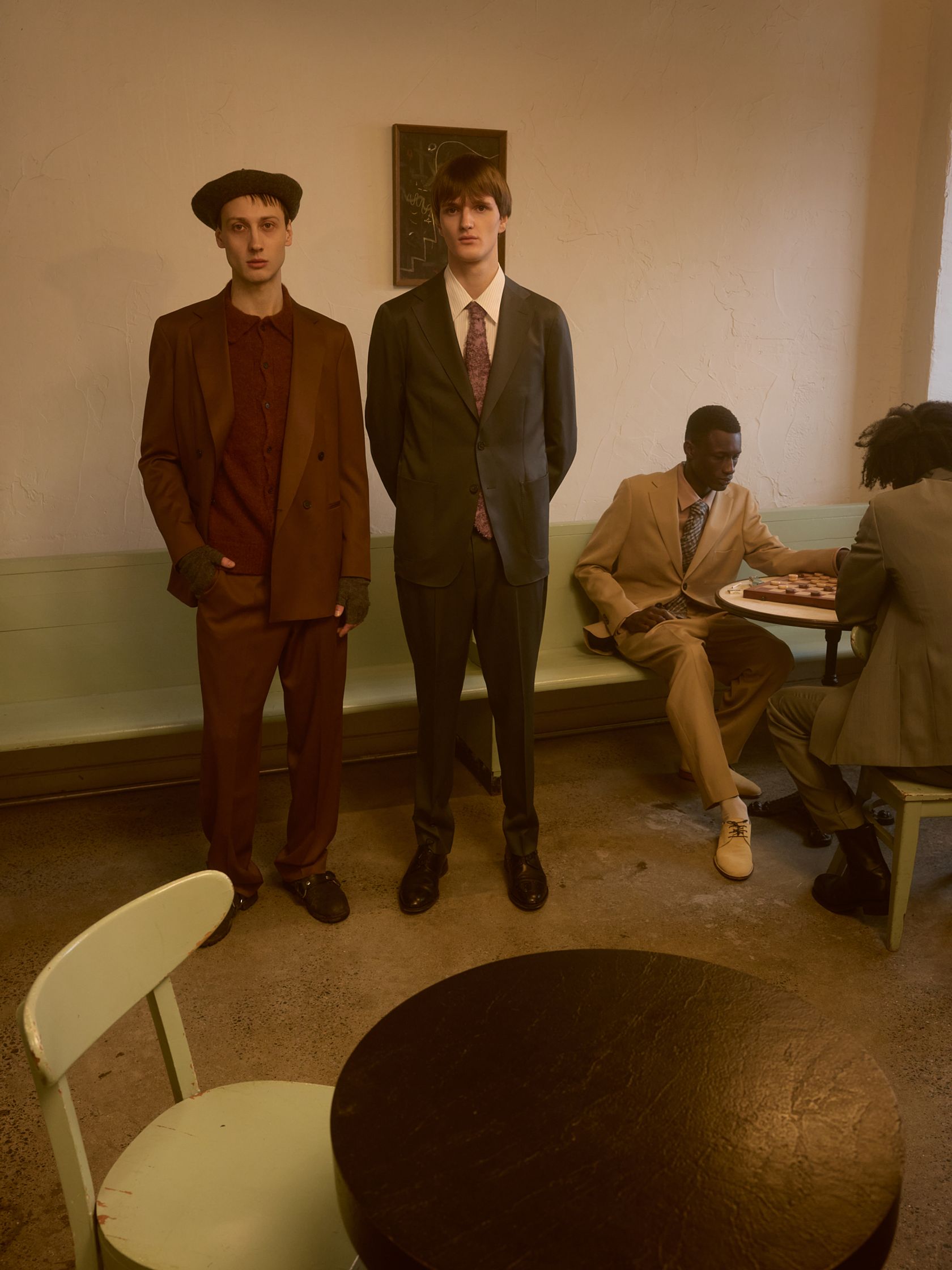 three men in suits standing in a room