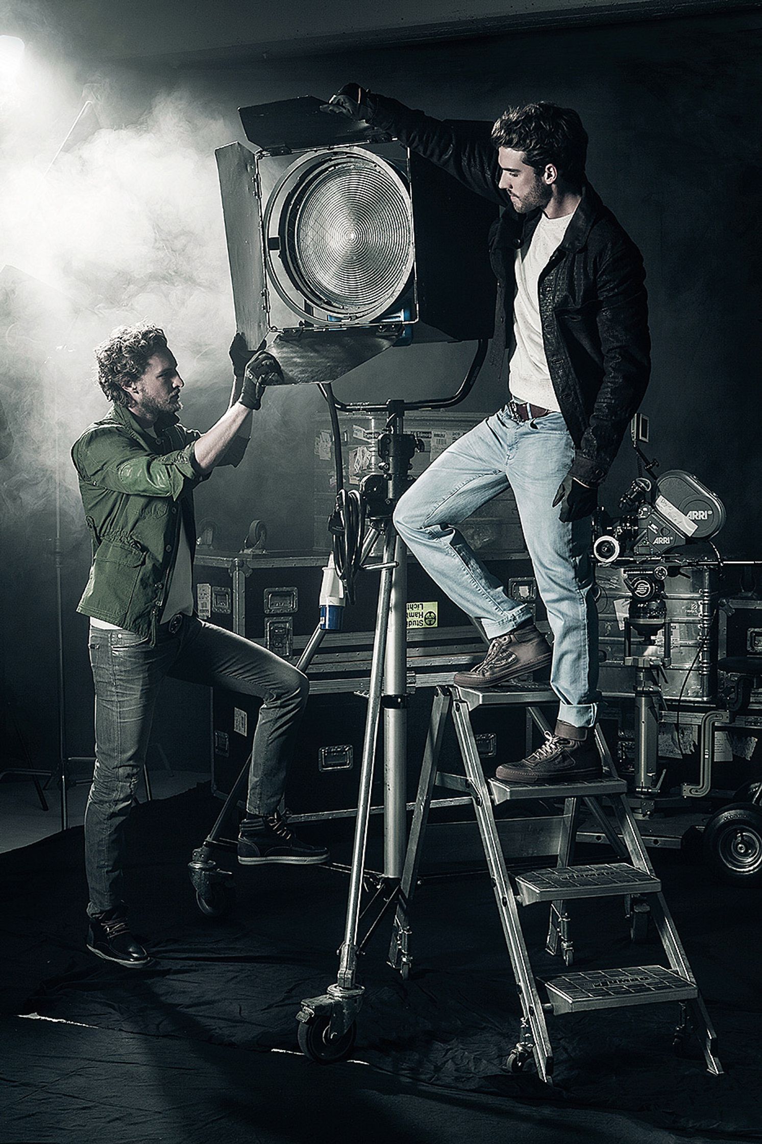 two men standing on a ladder next to a camera Post Production Hamburg