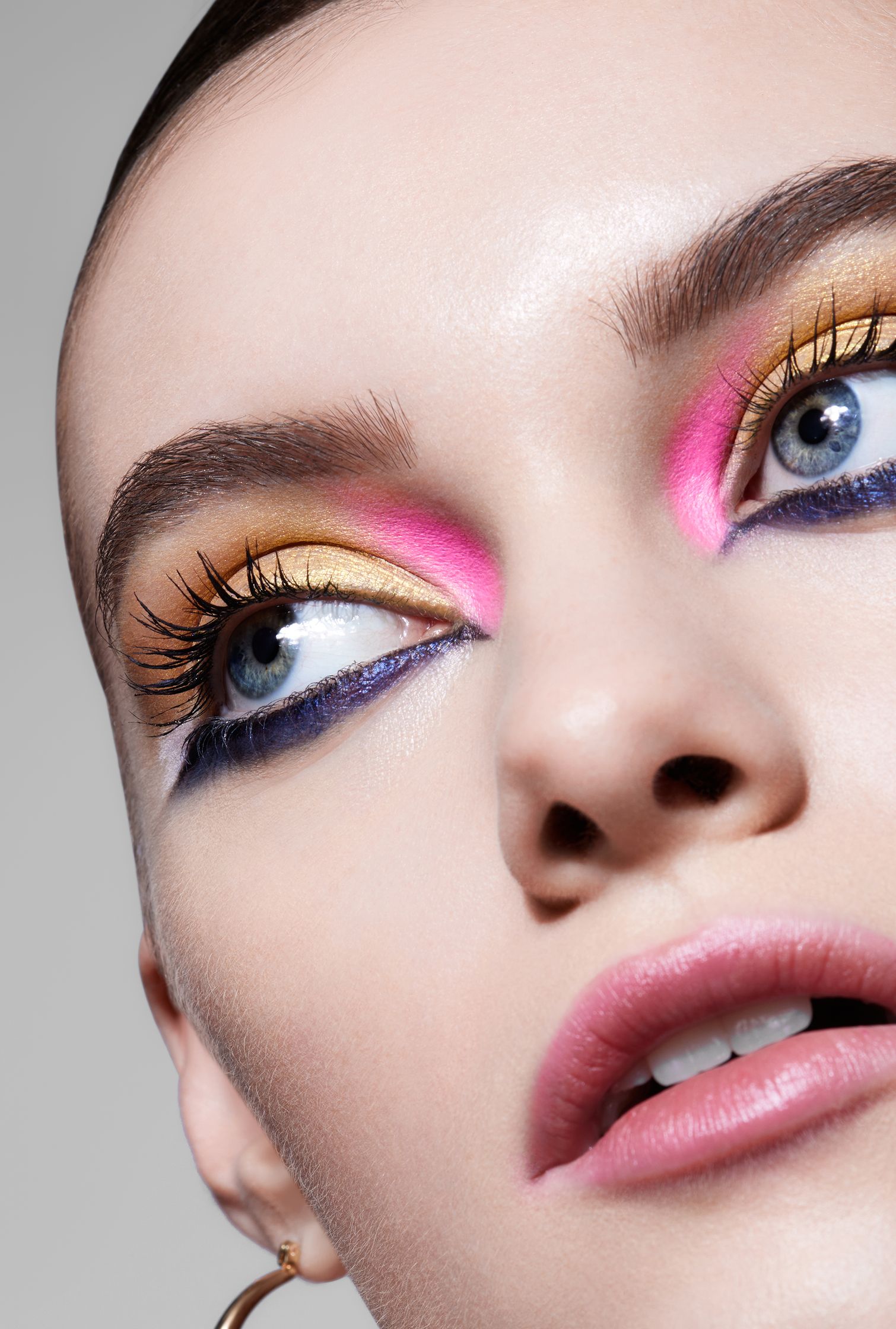 a woman with colorful eye makeup