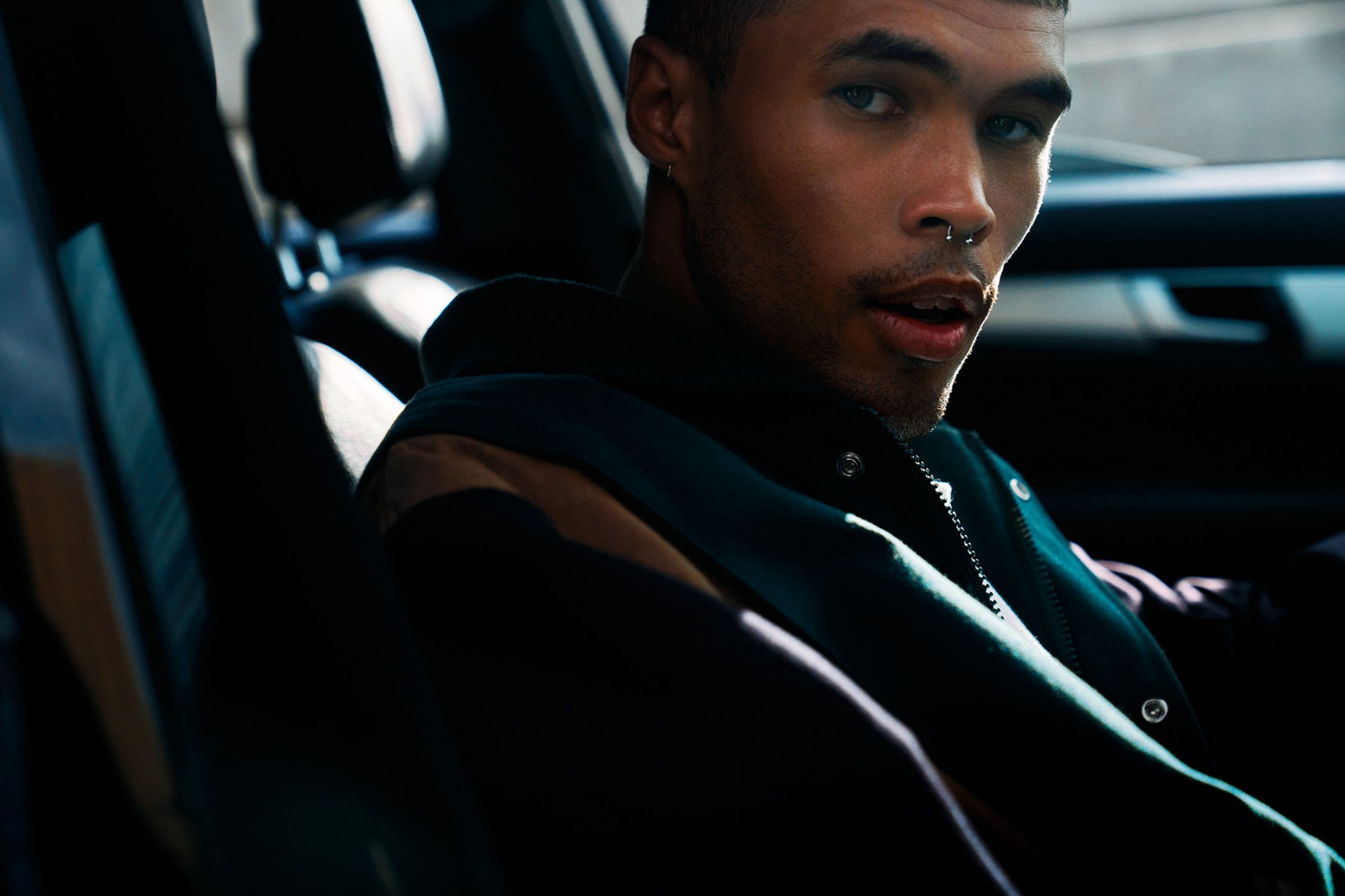 a man sitting in the back seat of a car