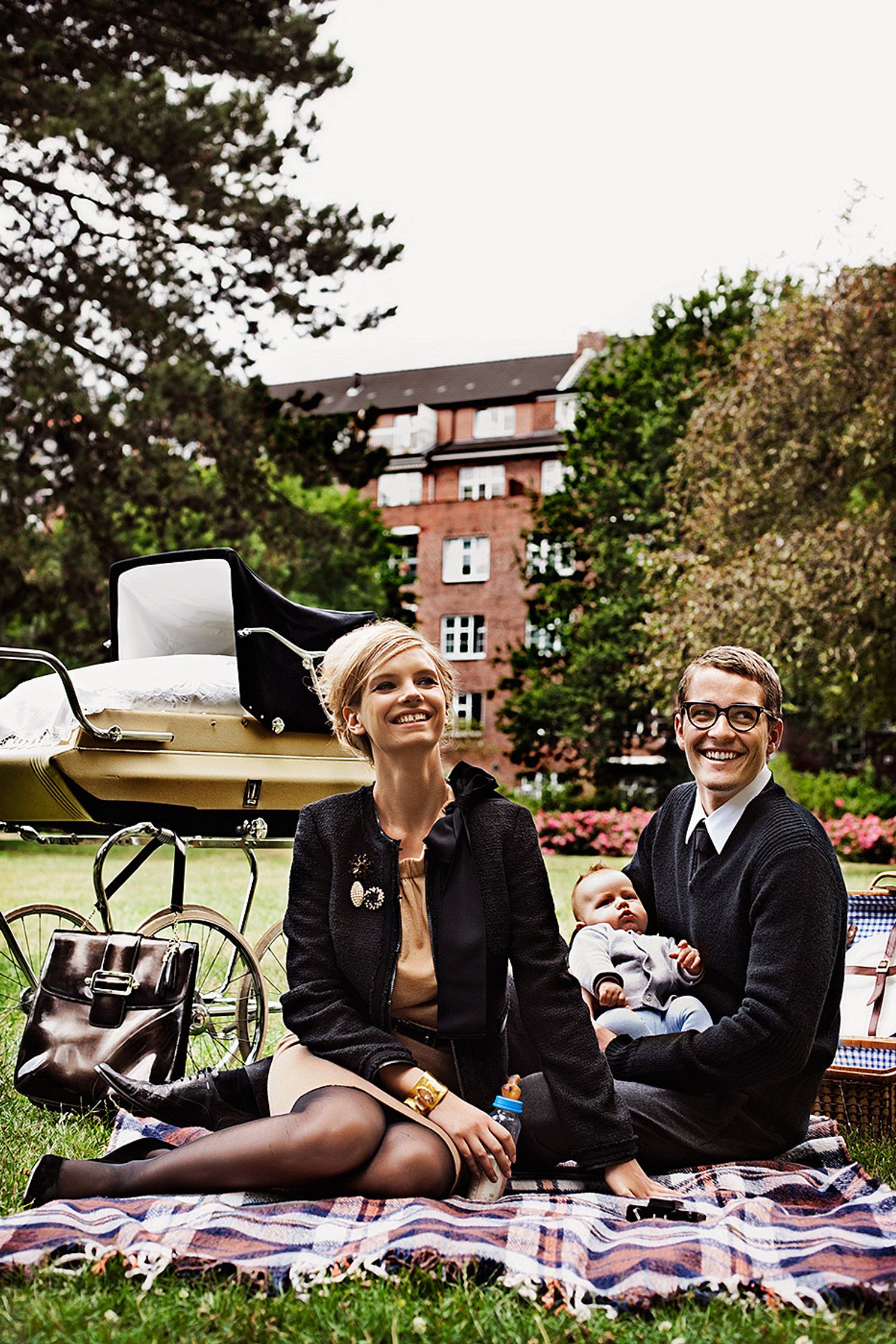 a man and woman sitting on a blanket in the grass creative retouch and look