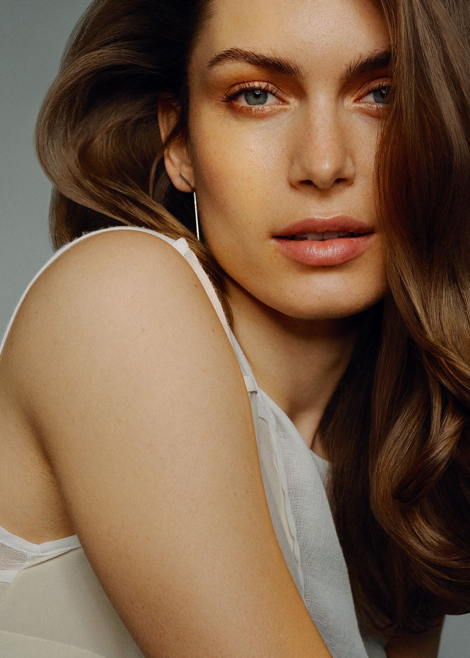 a woman with long brown hair posing for a photo