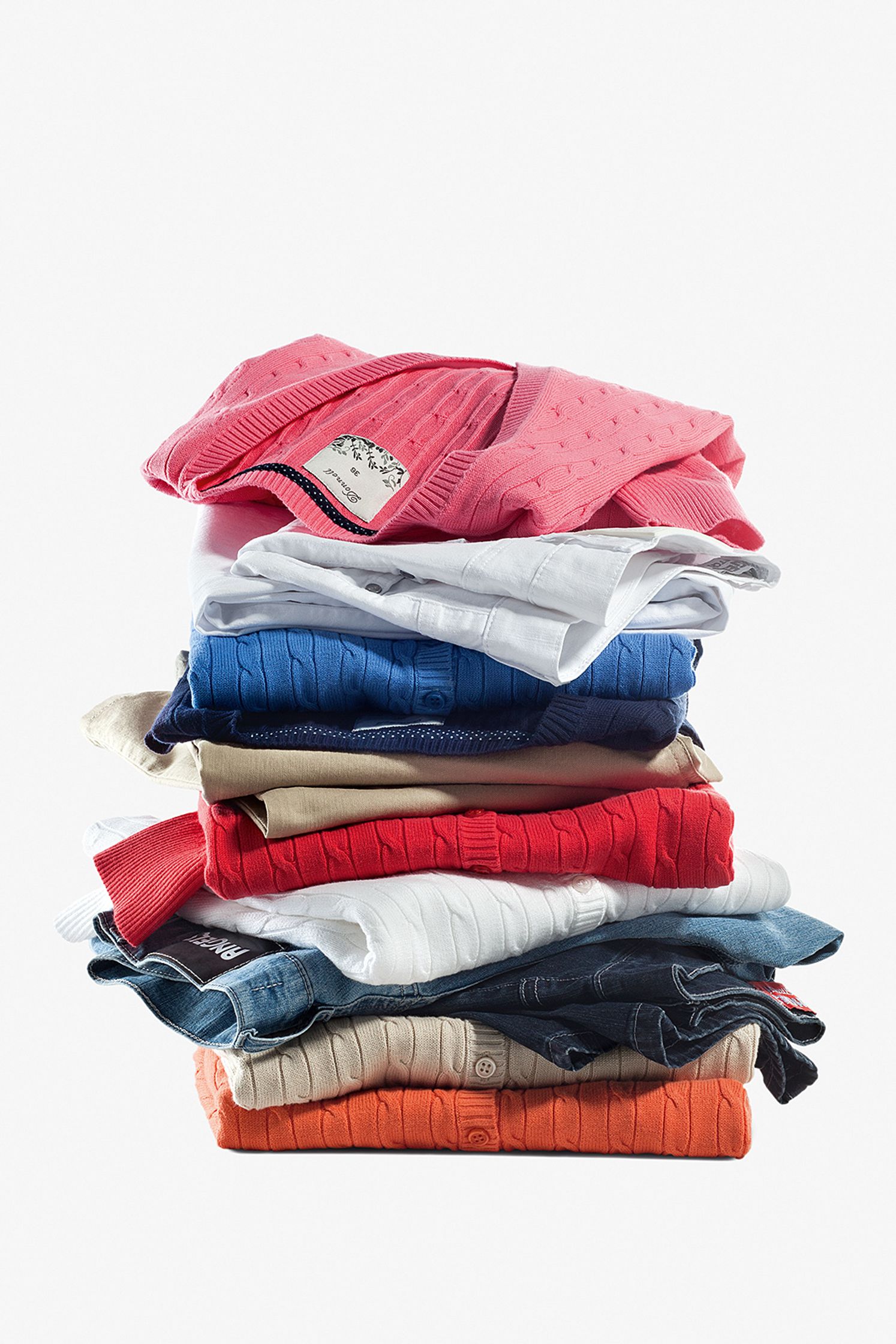 a stack of t - shirts on a white background Post Production Hamburg