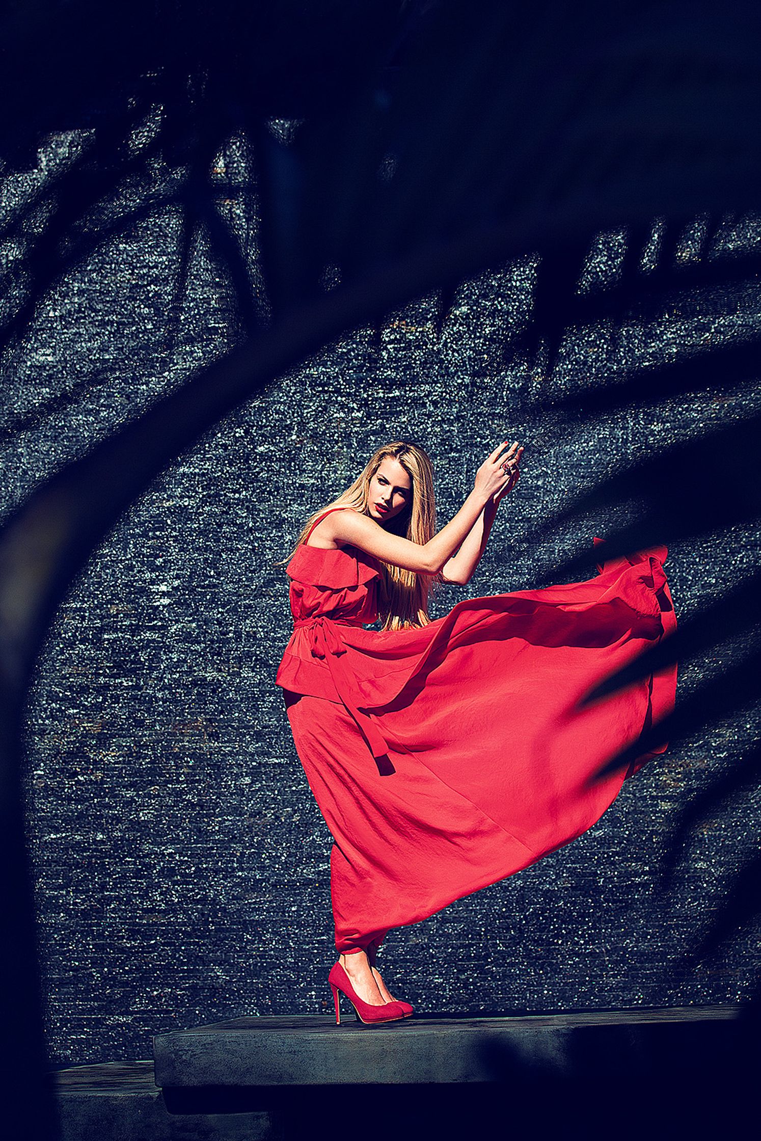 a woman in a red dress is dancing  Editorial Bildbearbeitung Hamburg