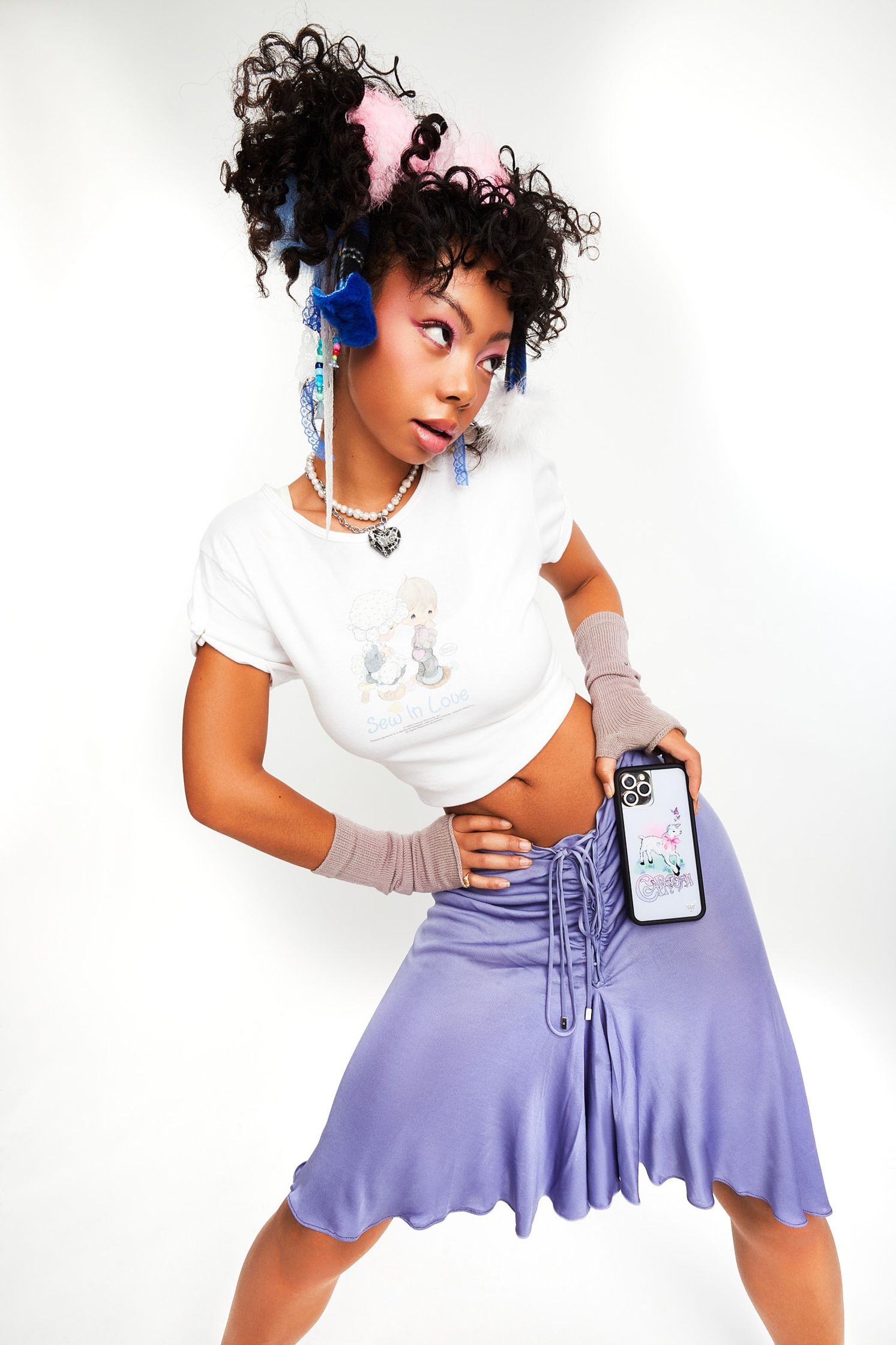 a woman in a purple skirt and t - shirt posing for a photo