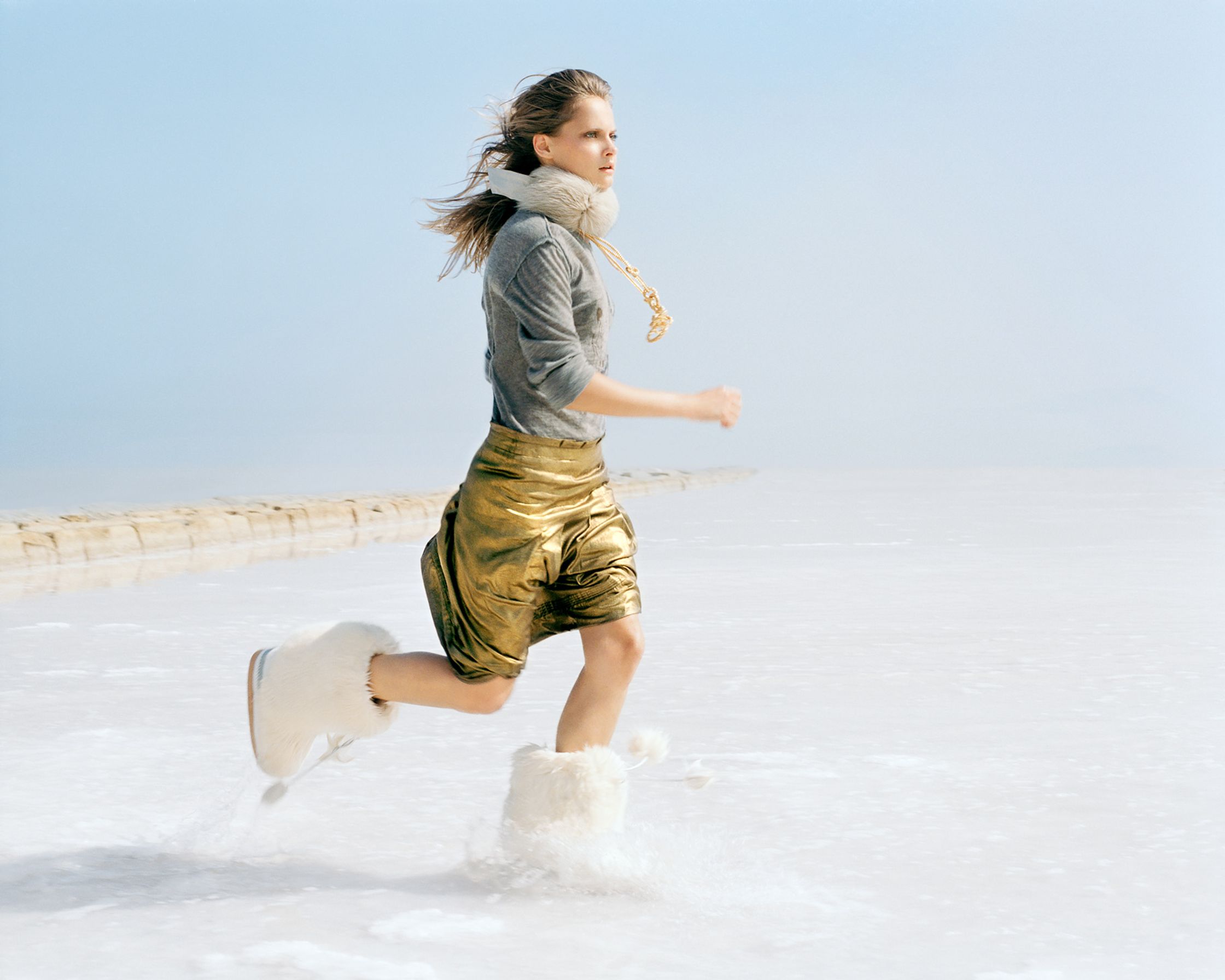 a woman is running in the snow on a frozen lake editorial retouching hamburg