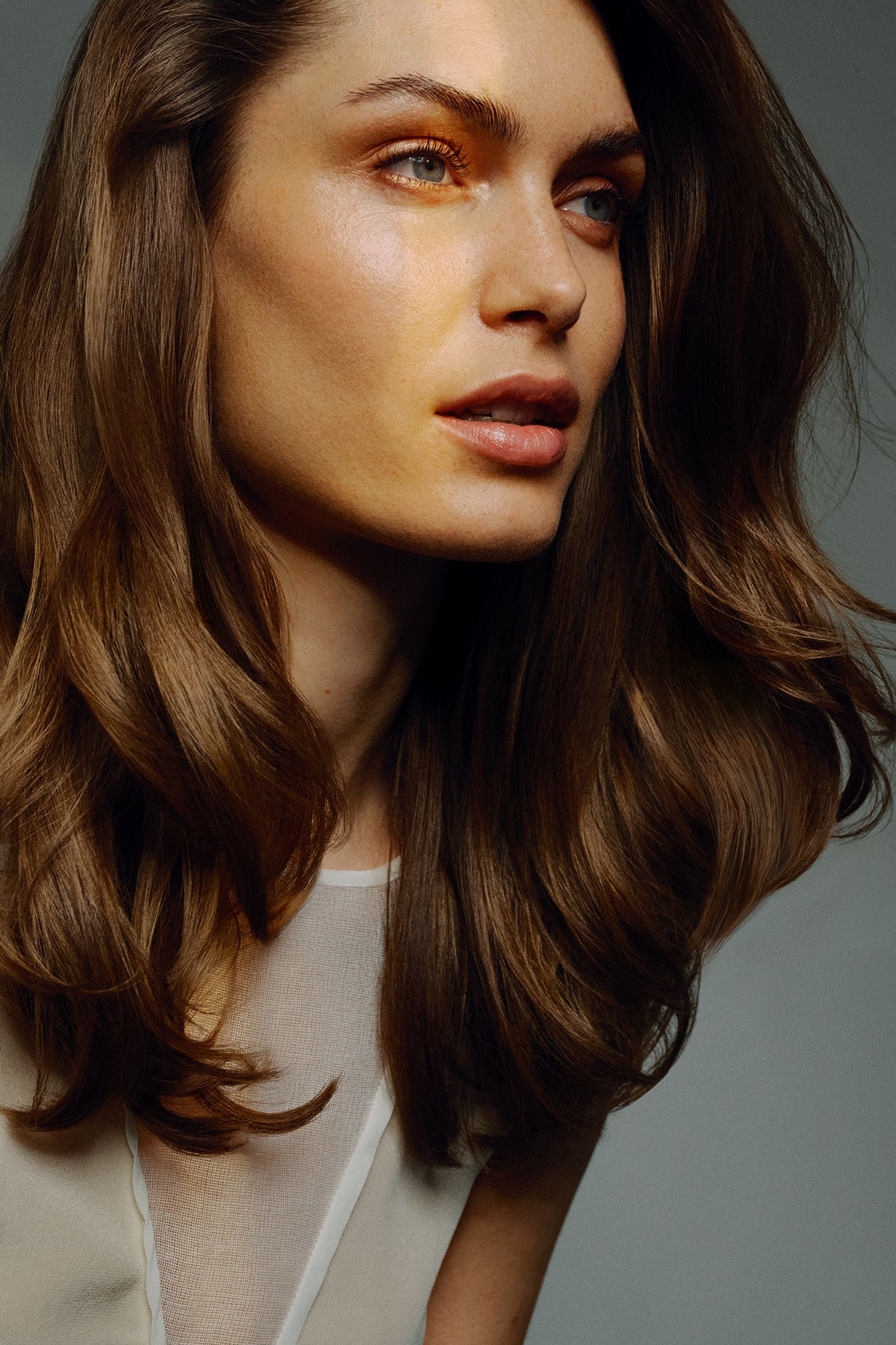 a woman with long brown hair is posing for a photo