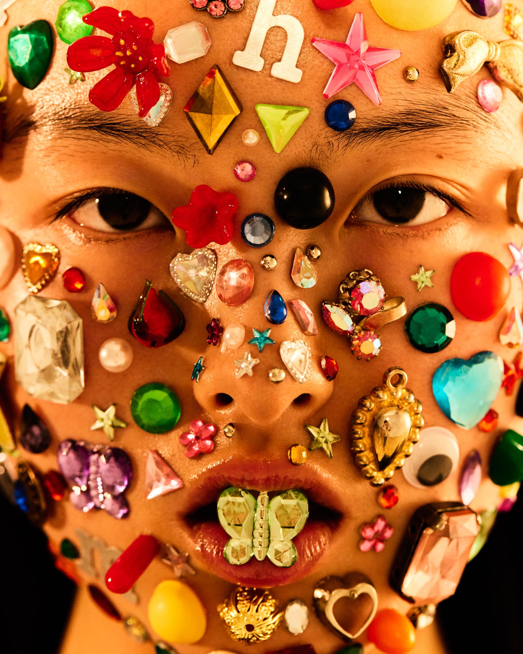 a woman's face covered with a lot of jewels