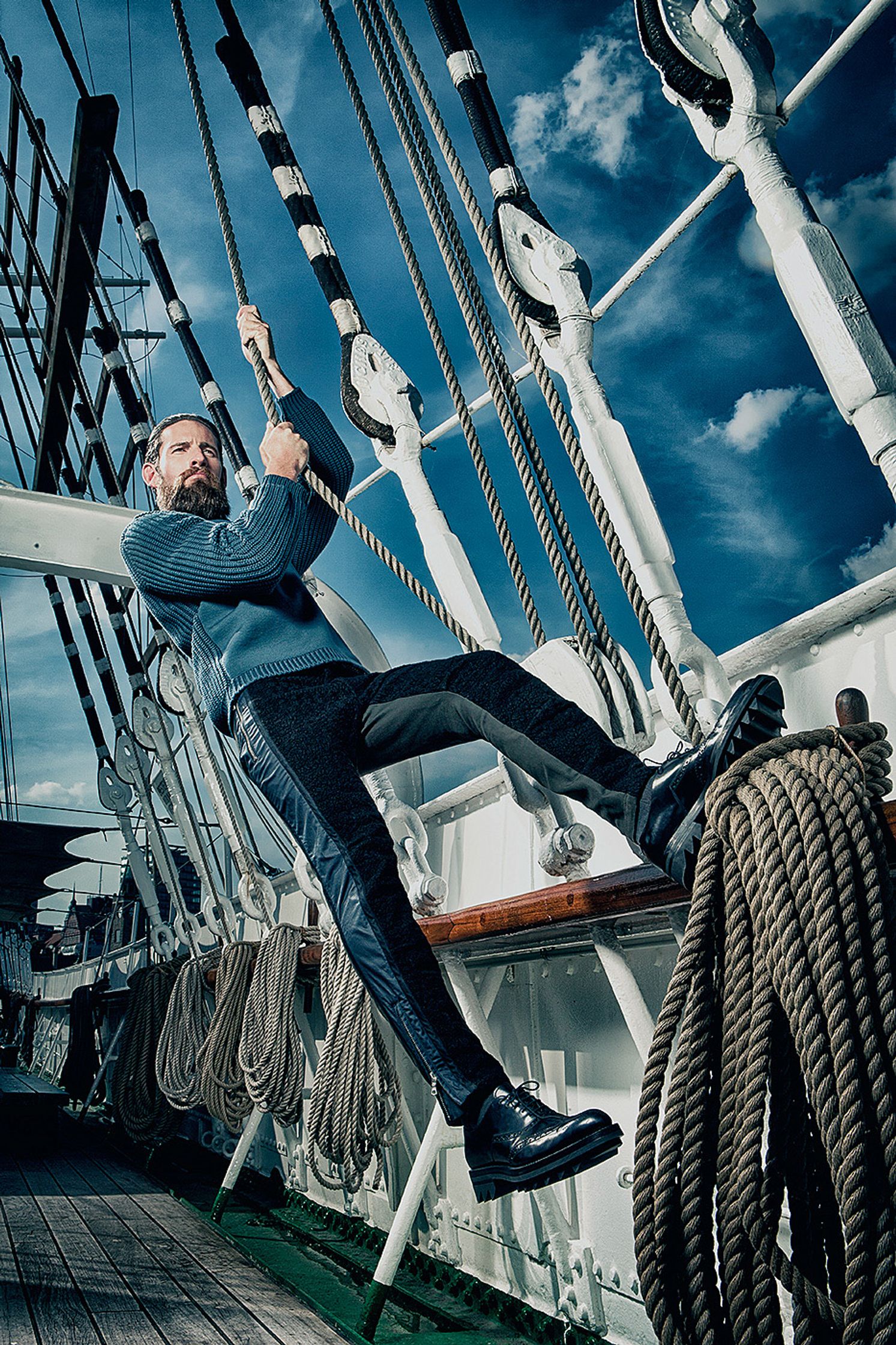 a man is hanging on the ropes of a ship Creative Retouching Hamburg