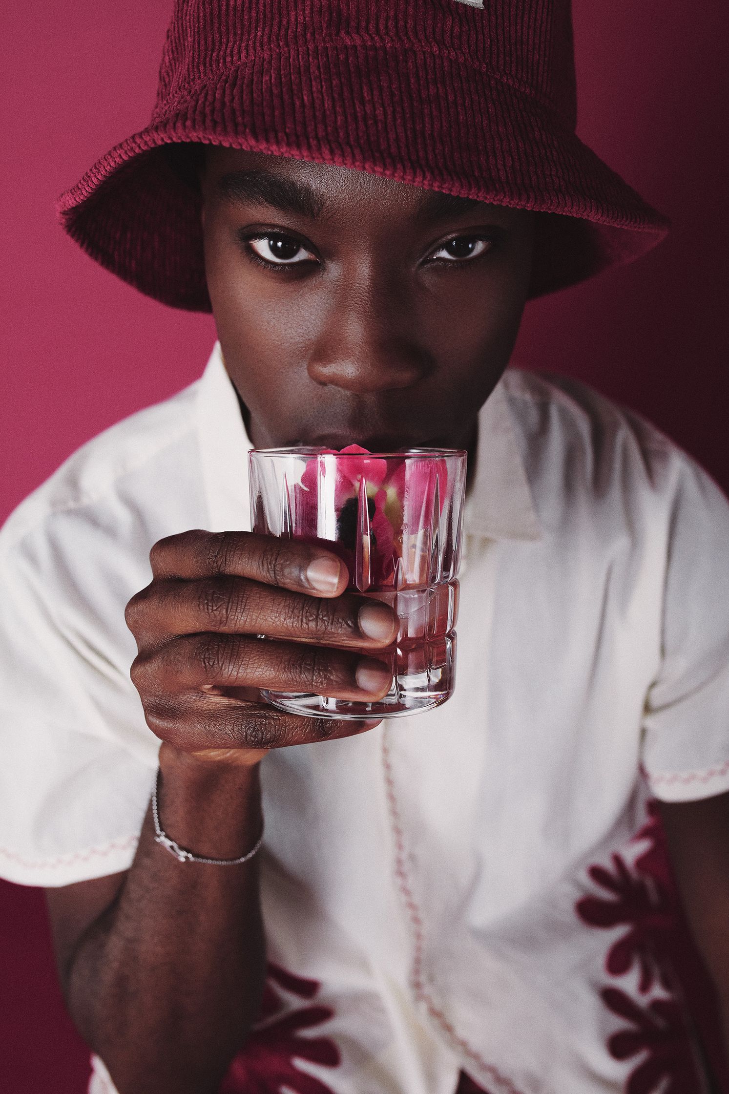 a man in a red hat drinking a glass of water