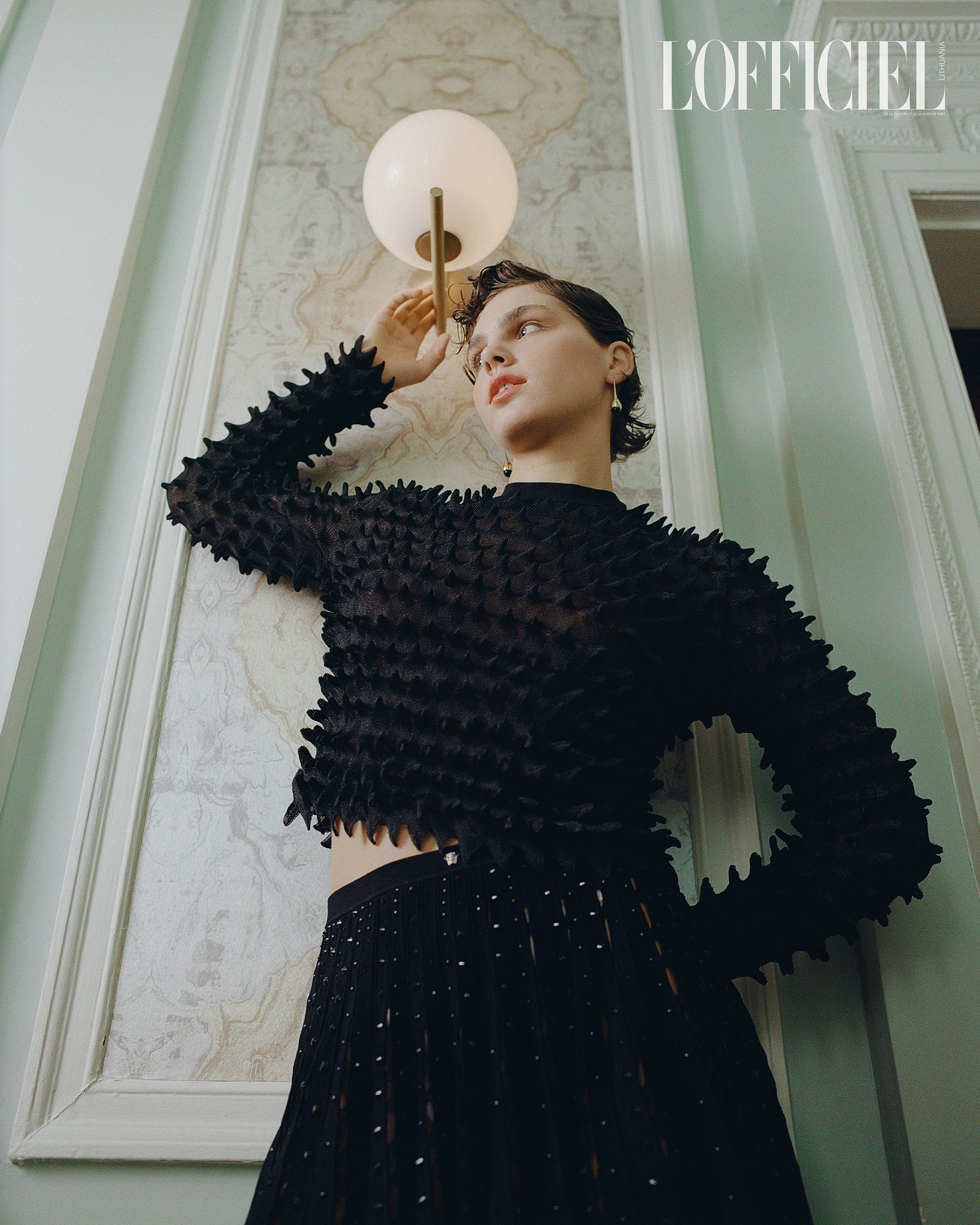 a woman is posing in a room with a lamp